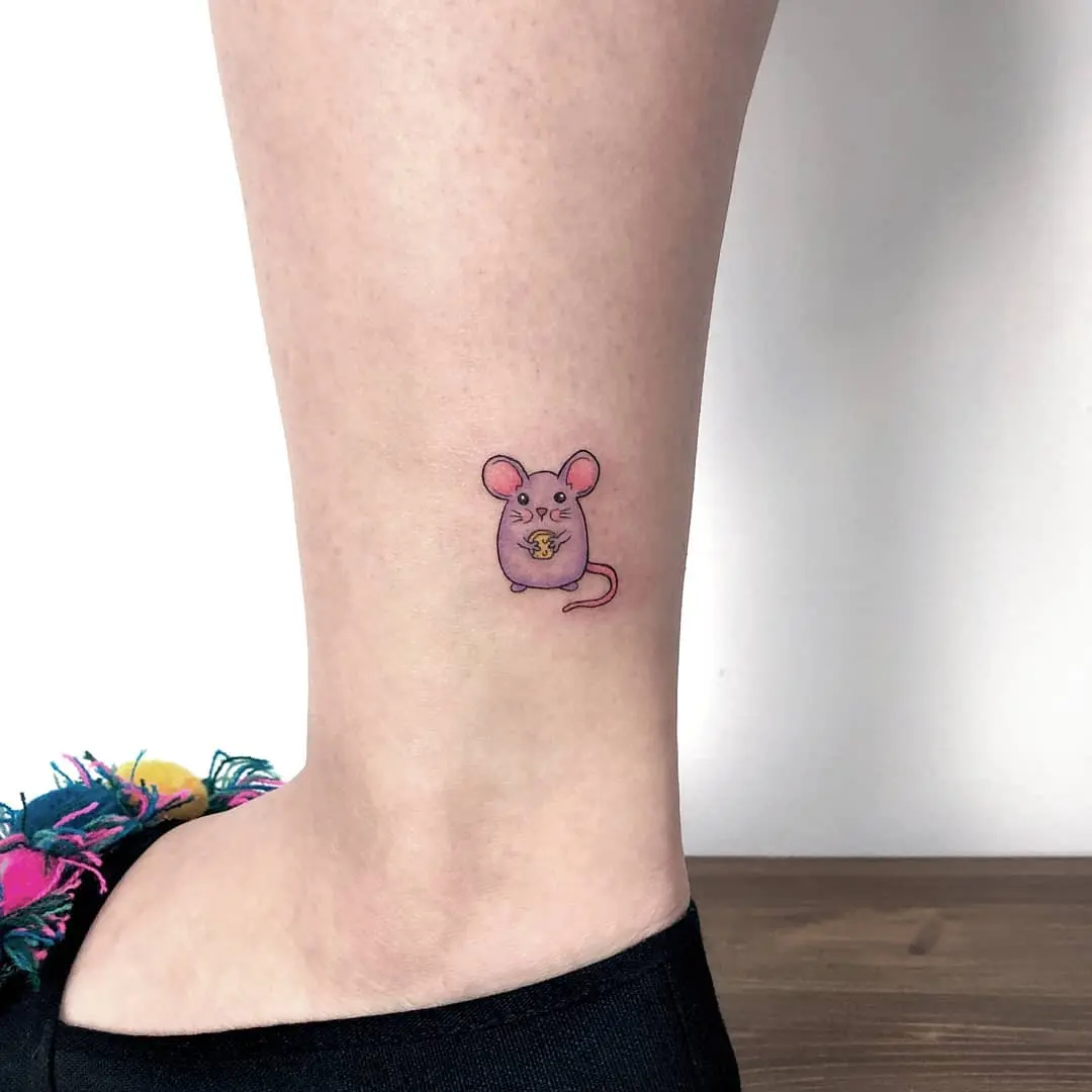 Whimsical mouse tattoo with cheese accents
