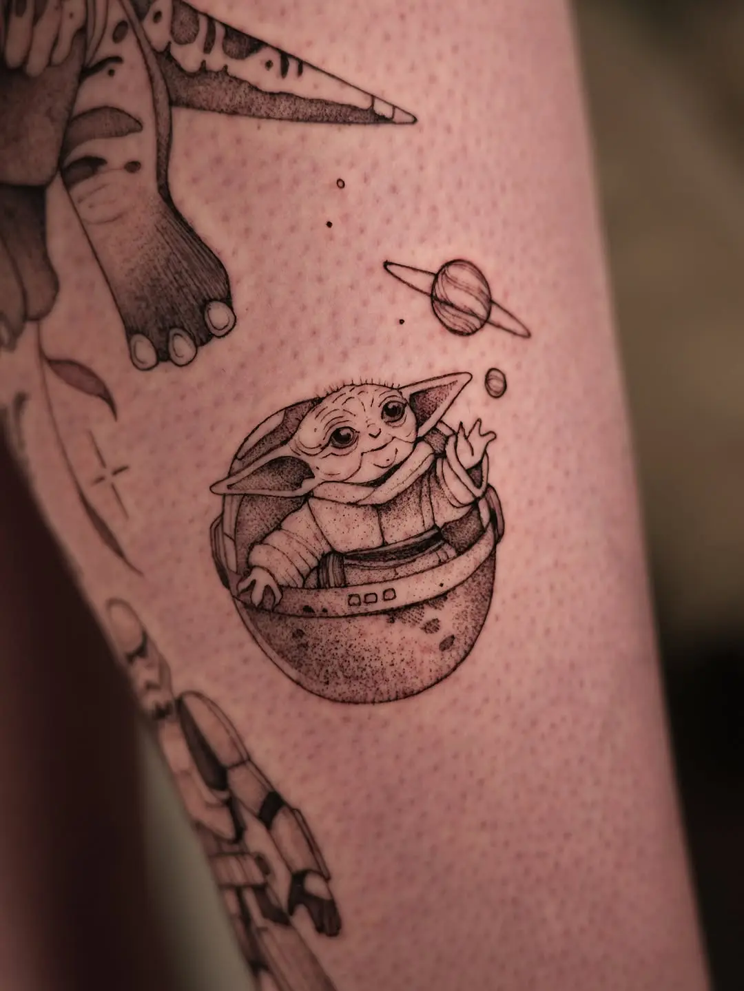 Charming Yoda tattoo in playful space setting