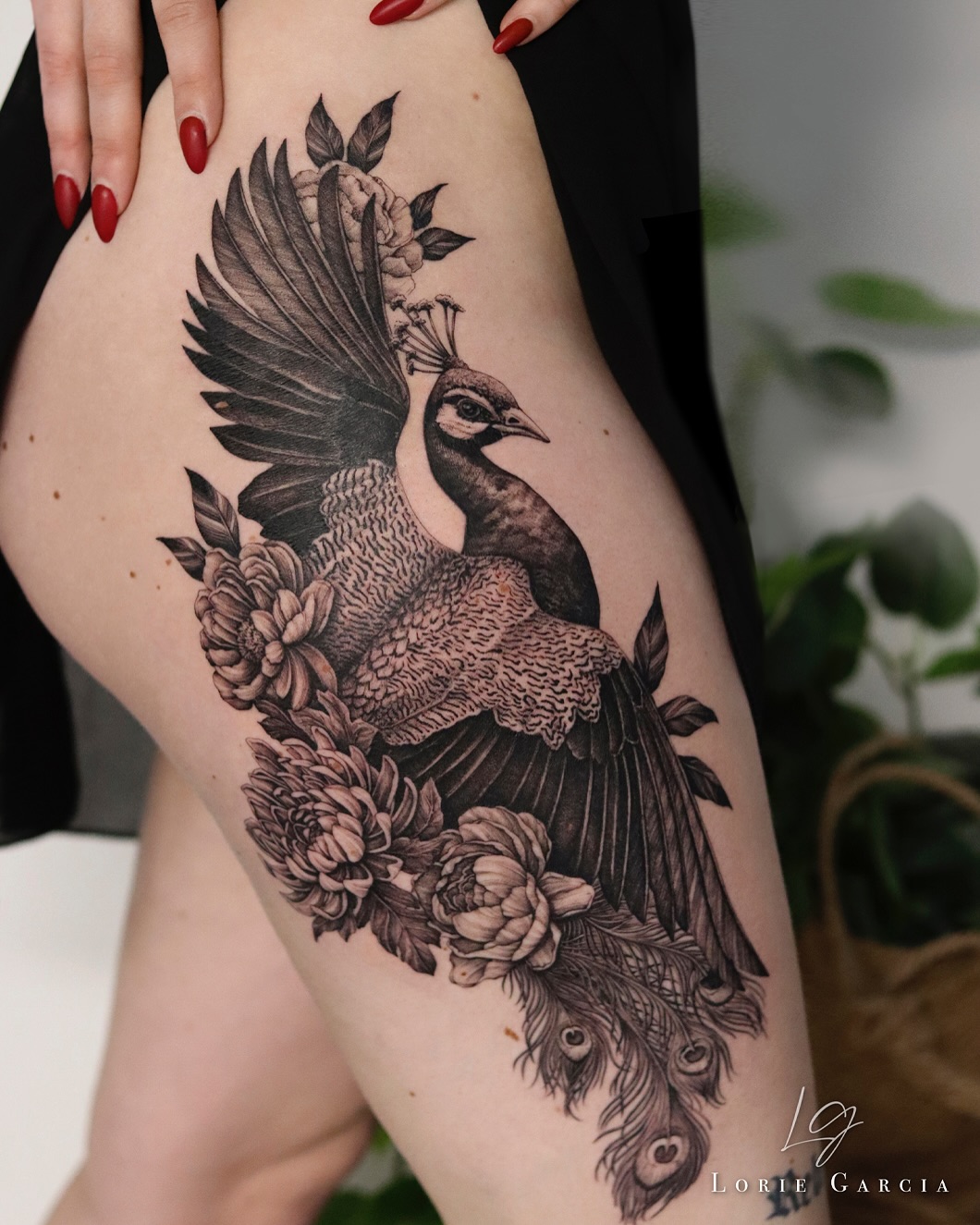 Intricate peacock tattoo with floral elements