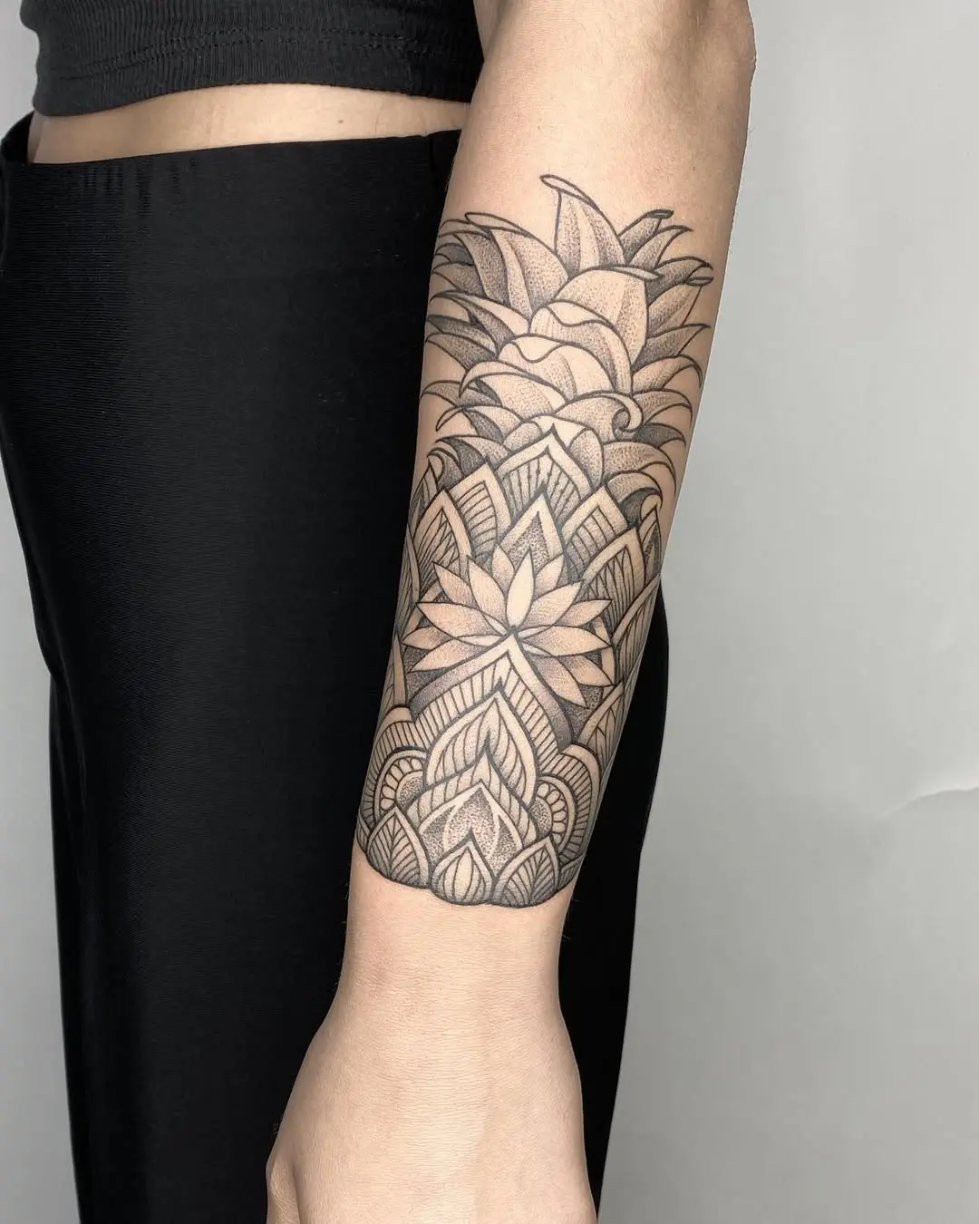 Intricate geometric pineapple tattoo with floral elements