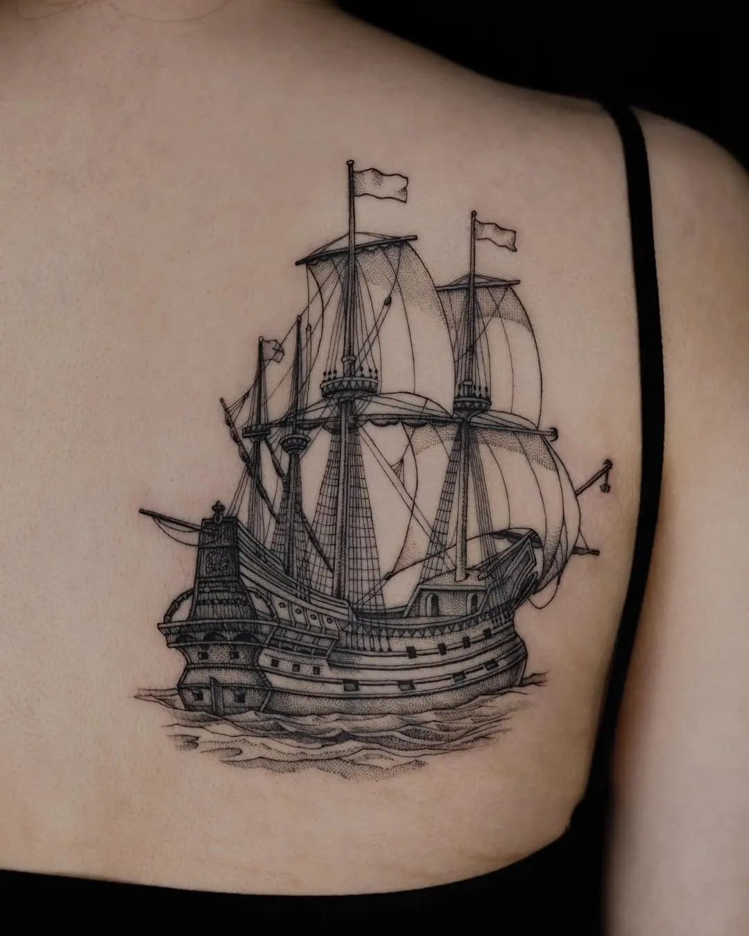 Intricate ship tattoo beautifully designed on the back