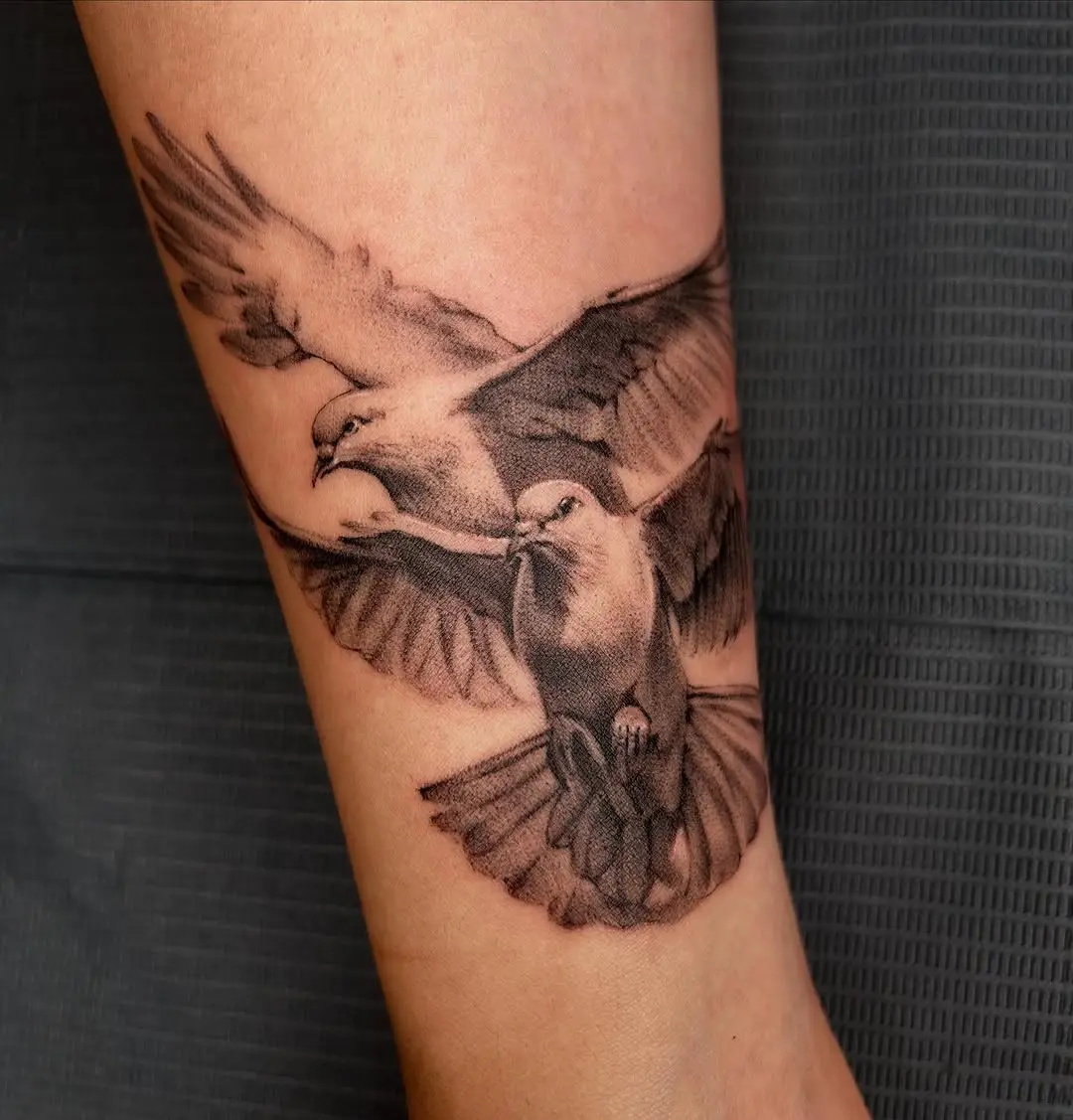 Elegant flying dove tattoo design on forearm
