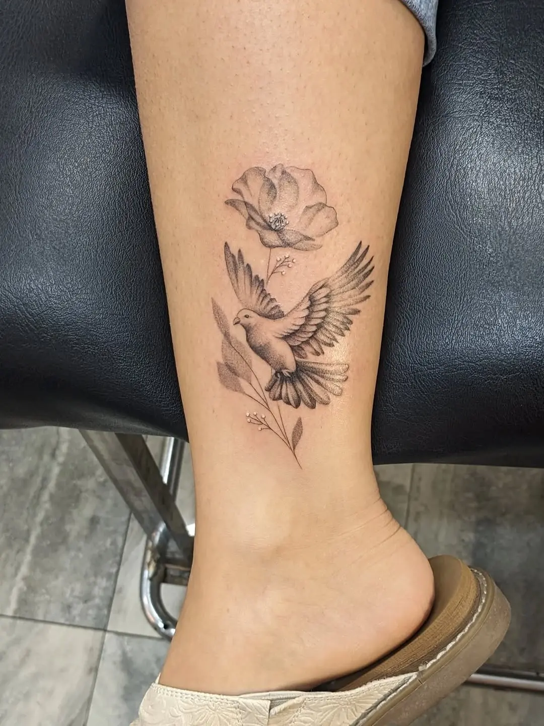 Elegant dove tattoo with floral accents