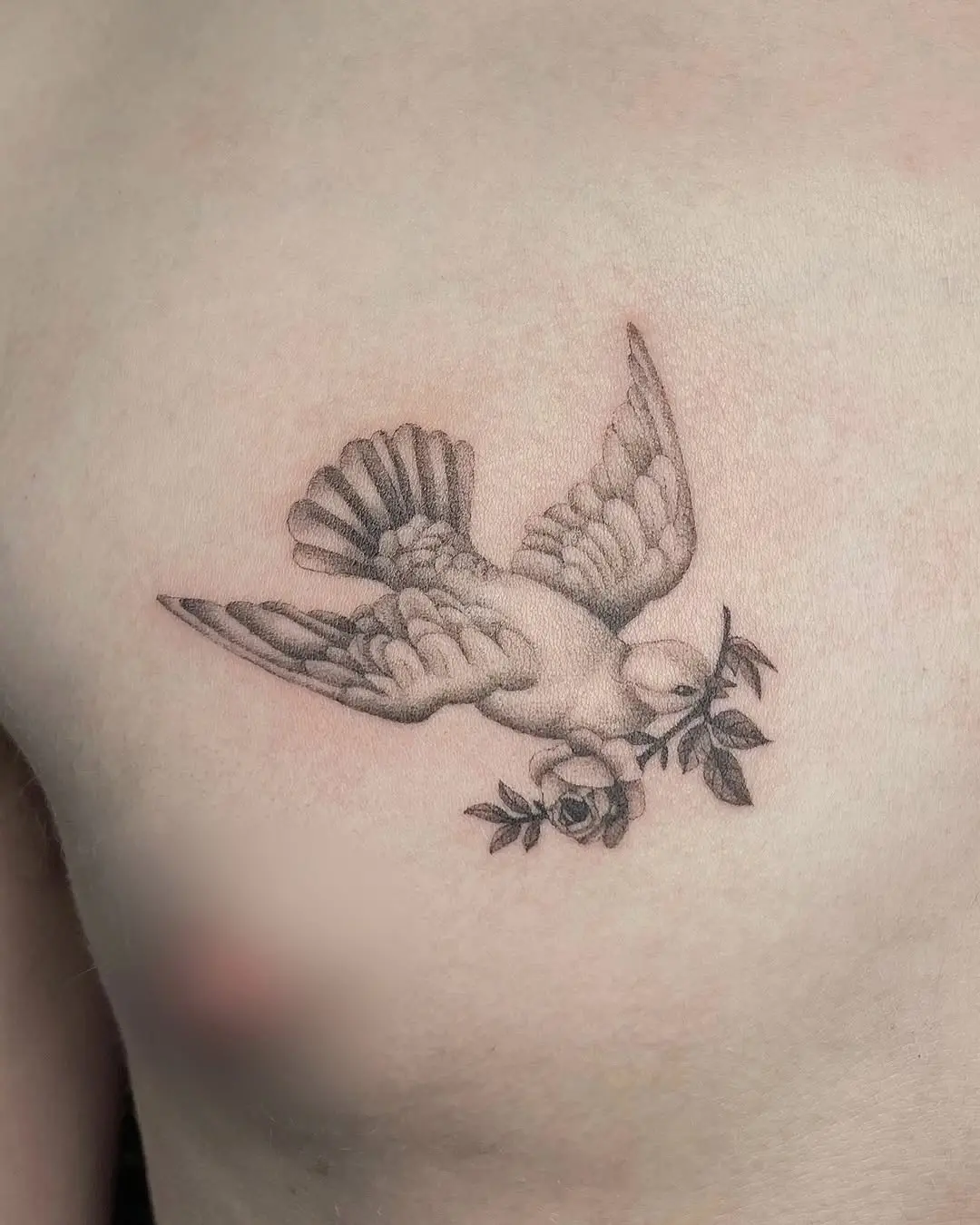 Elegant flying dove with rose branch tattoo