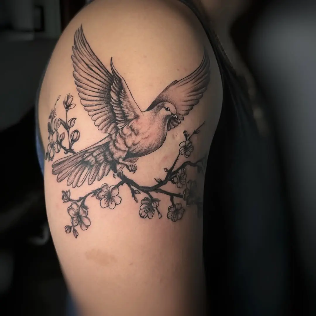 Elegant dove tattoo perched on a branch