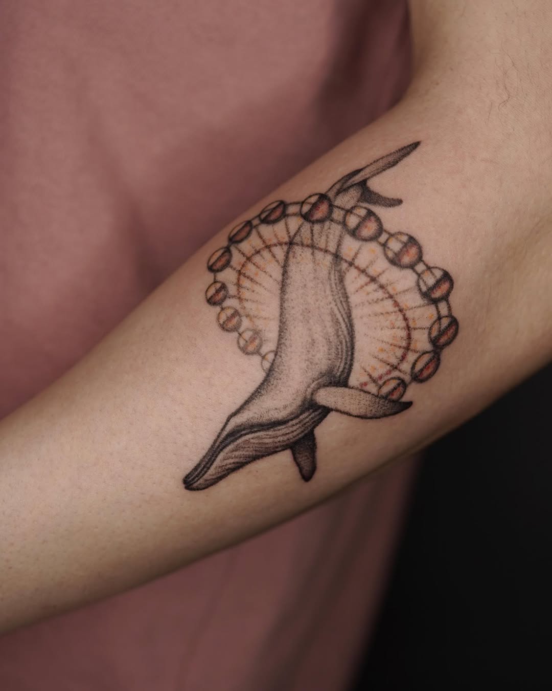 Whimsical dolphin rides a ferris wheel tattoo