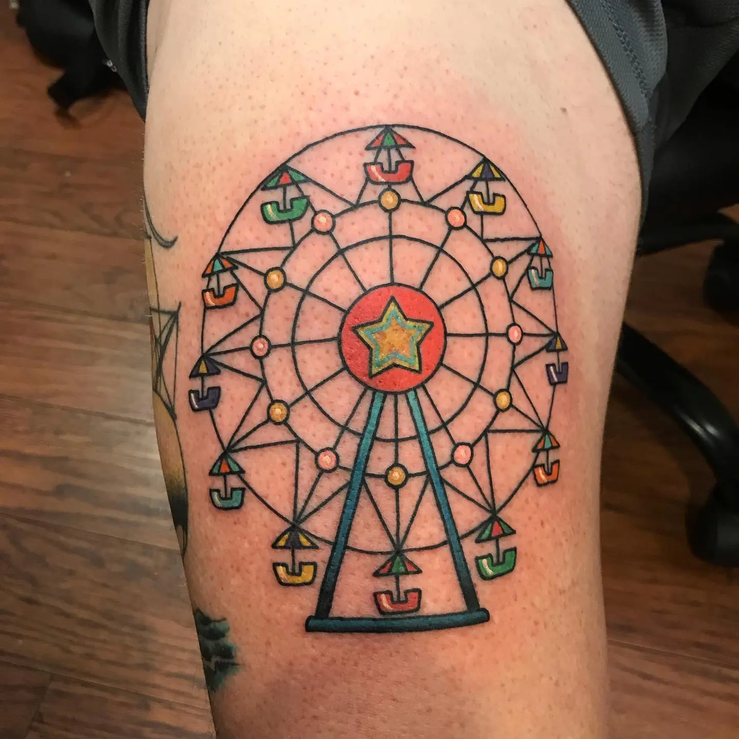Vibrant Ferris Wheel Tattoo with Star Charm
