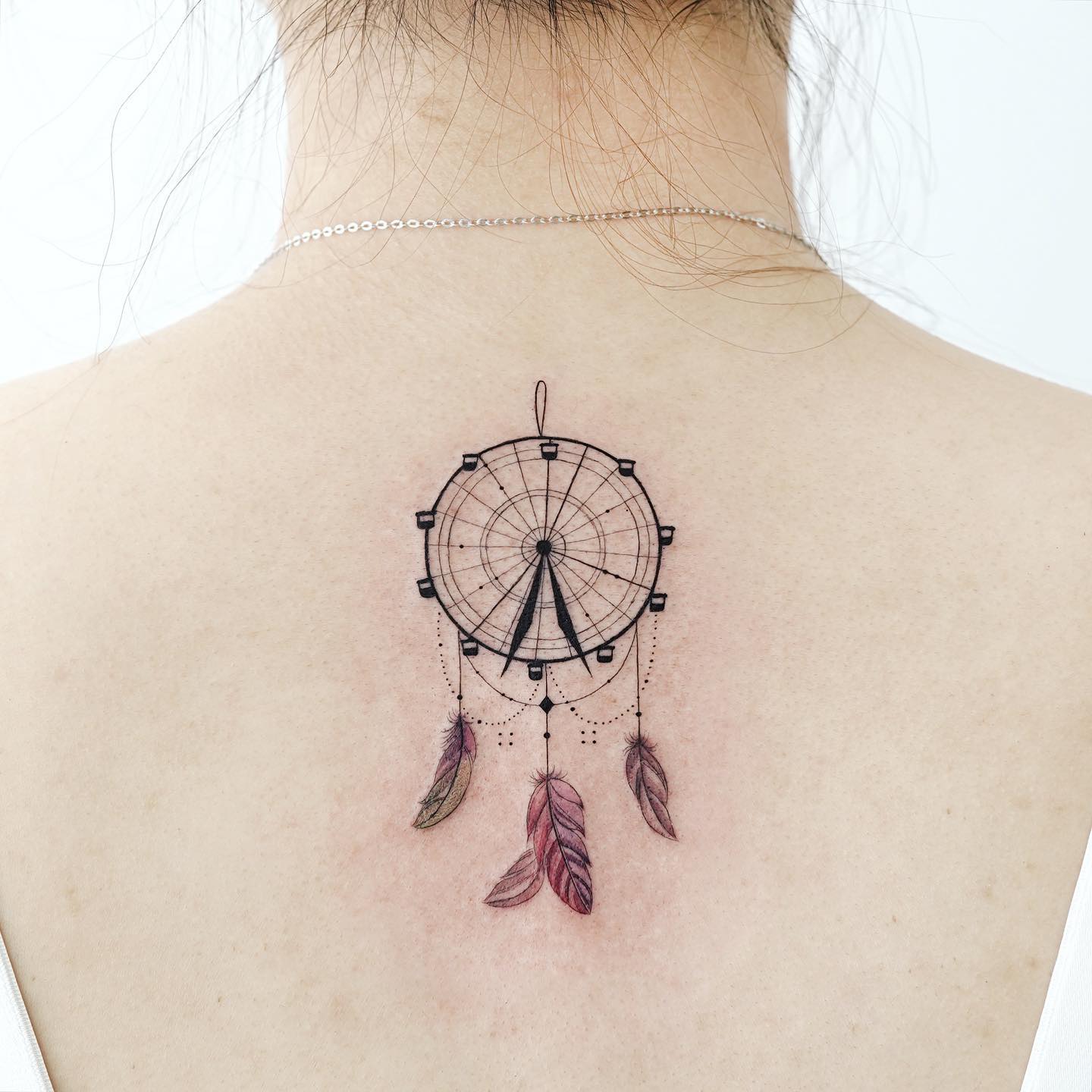 Charming Ferris Wheel Tattoo with Feathers