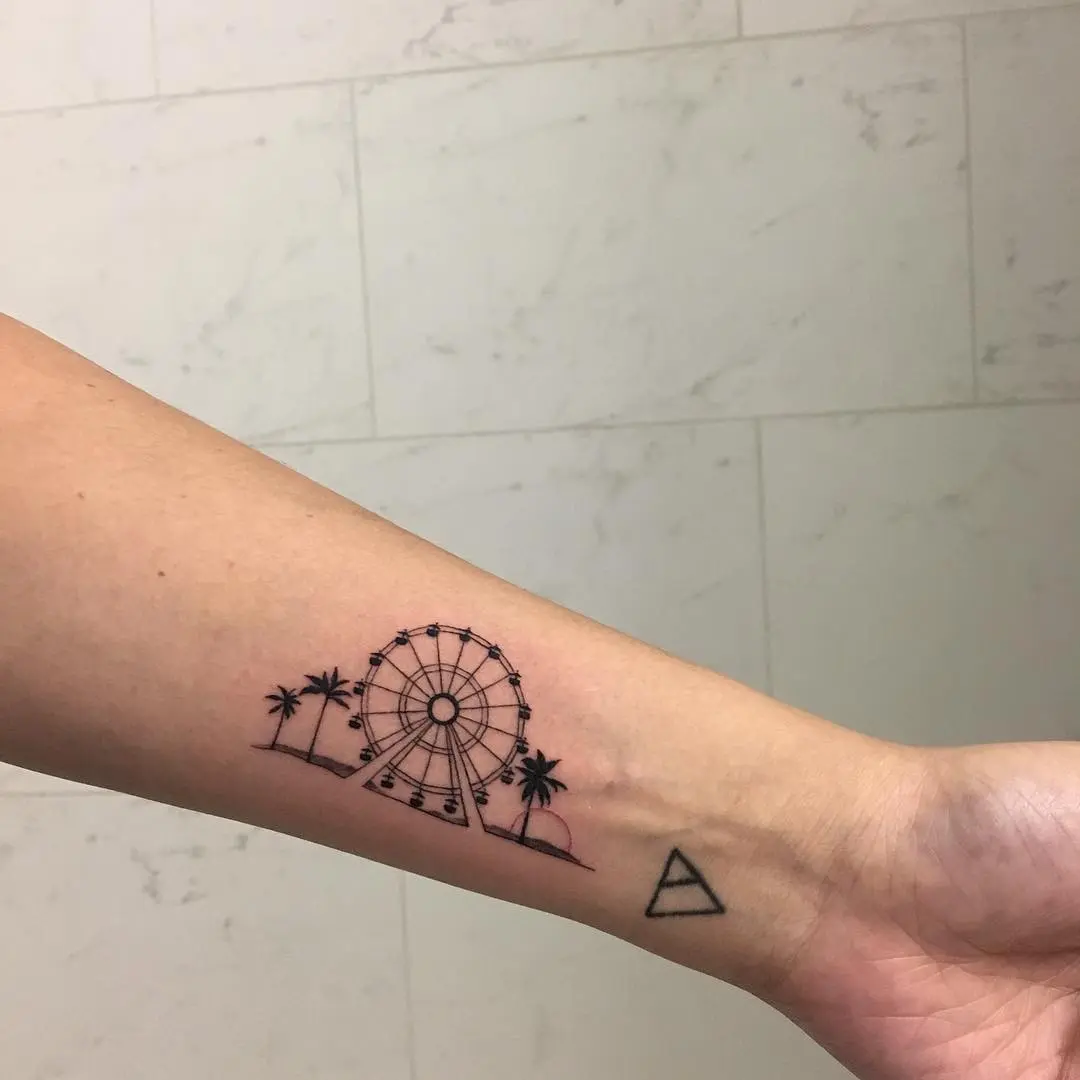 Sleek Ferris wheel tattoo with palm trees