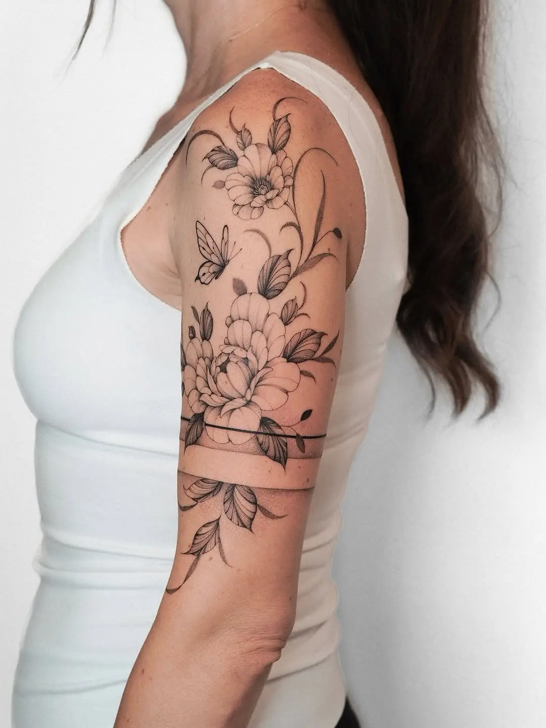 Elegant floral armband tattoo with butterflies