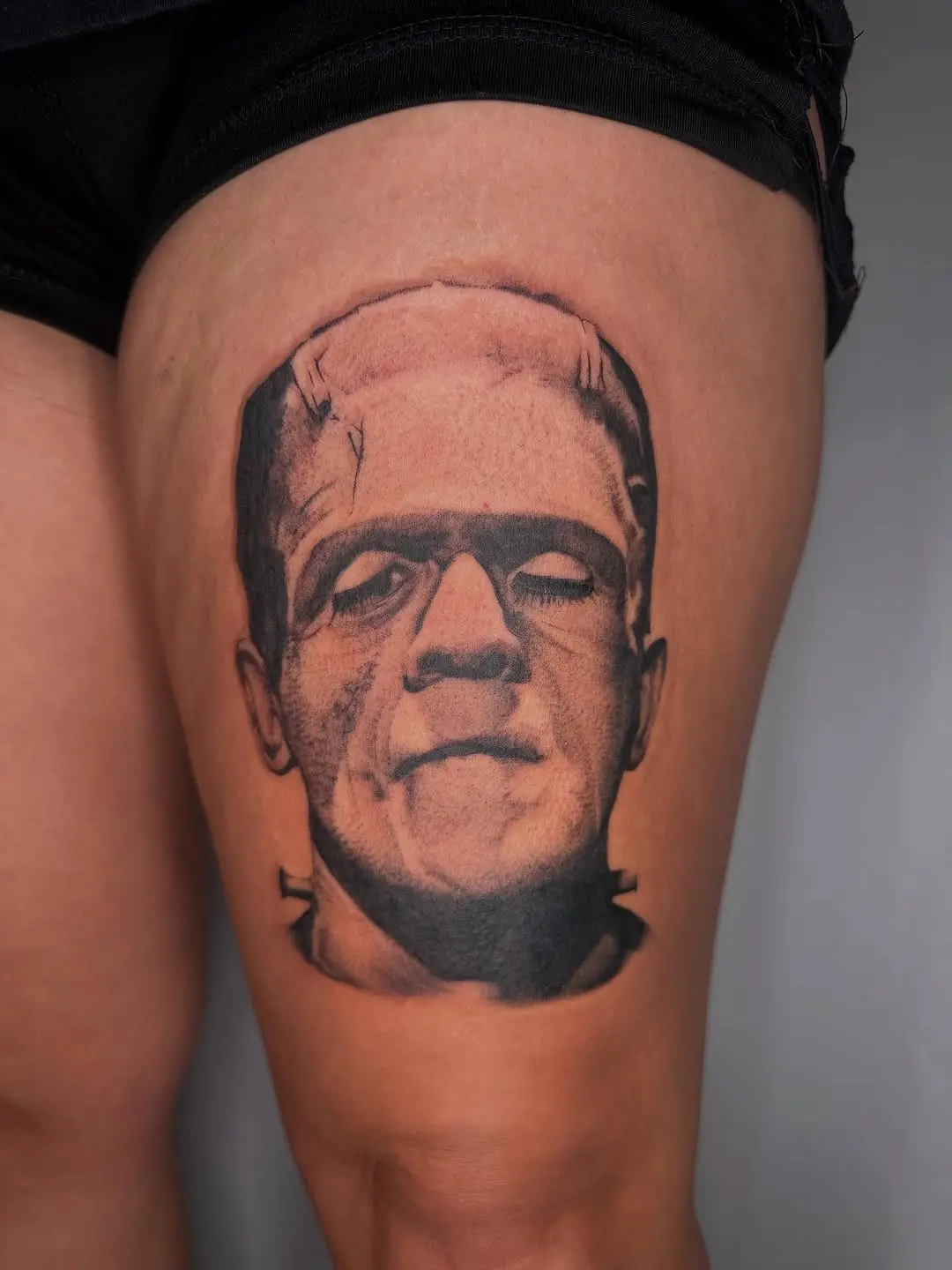 Iconic Frankenstein tattoo in bold black and gray