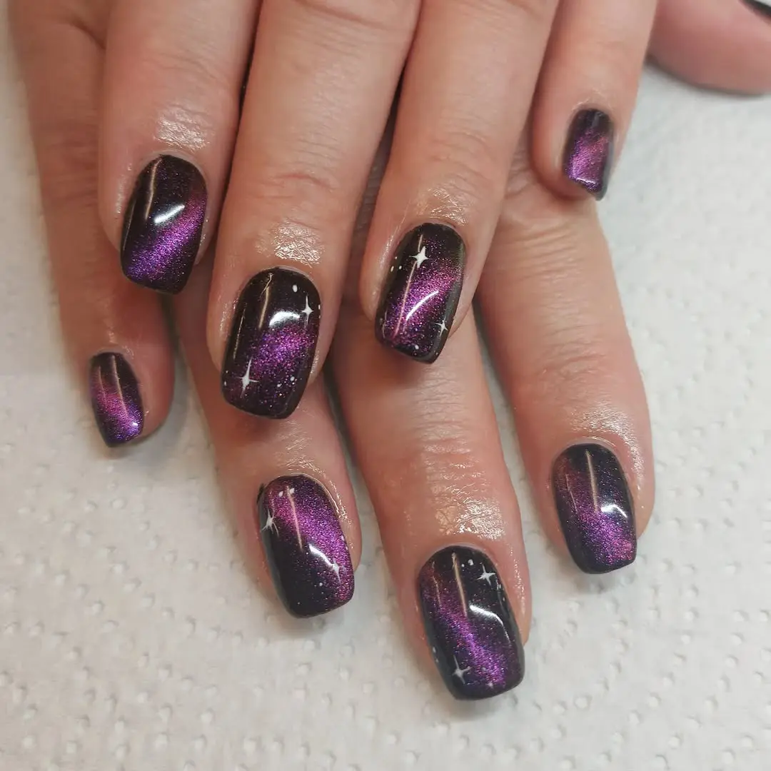 Mesmerizing galaxy-inspired purple glitter nails