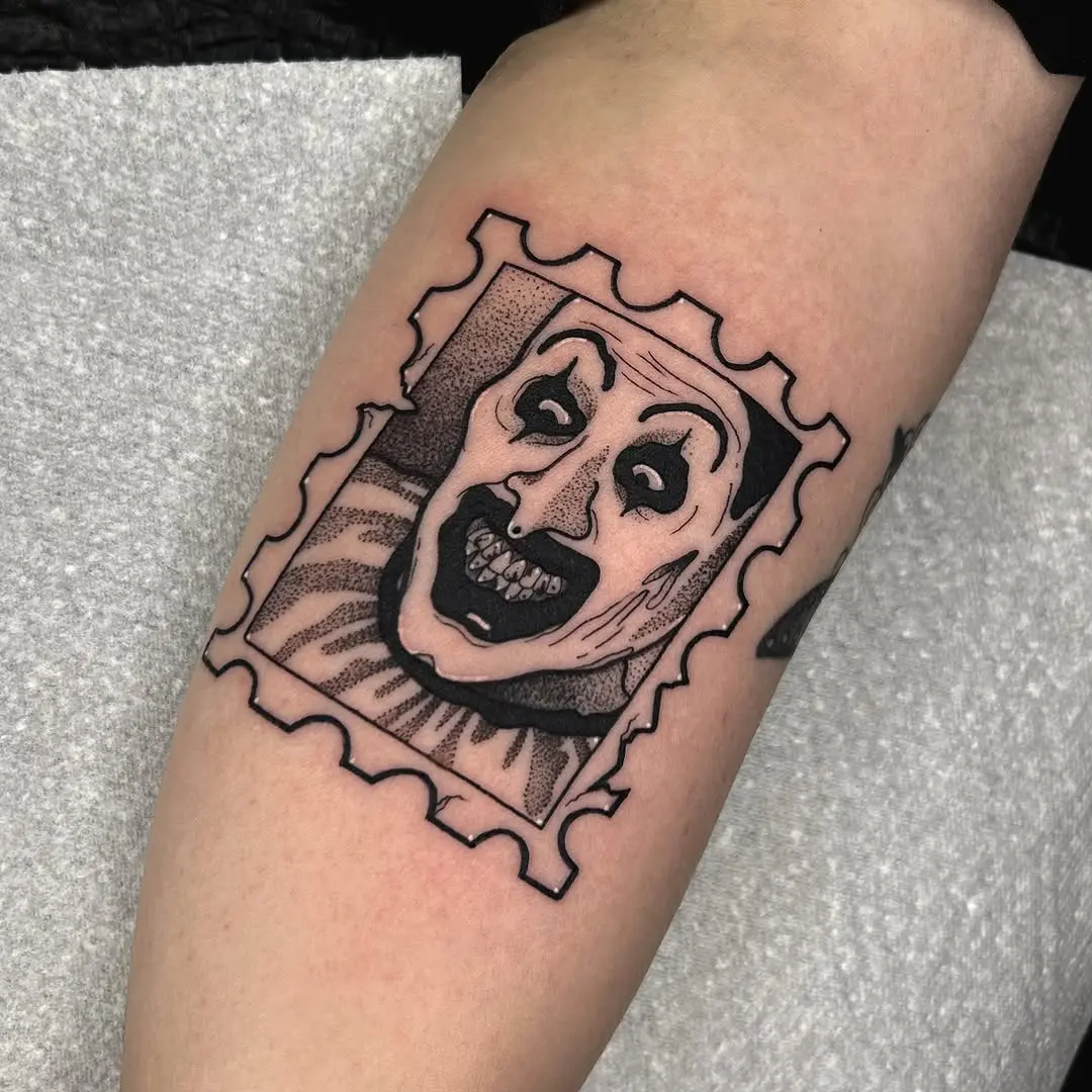 Chilling clown tattoo in stamp design