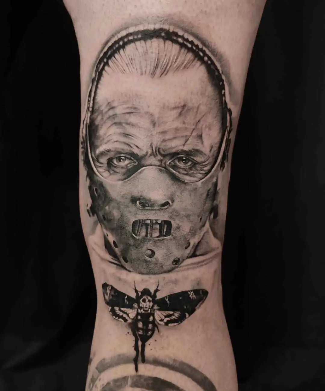 Intricate horror tattoo featuring classic motifs