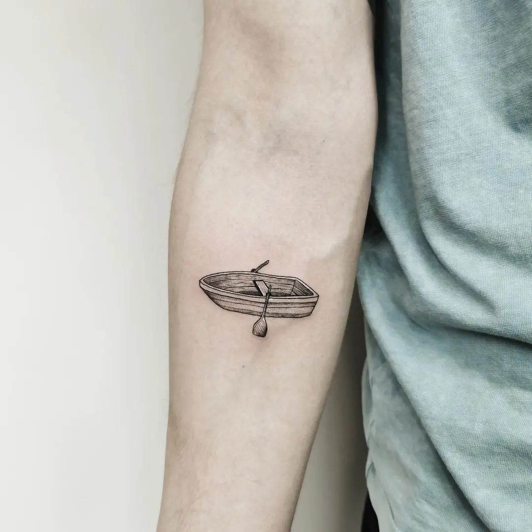 Elegant minimalist boat tattoo design on arm
