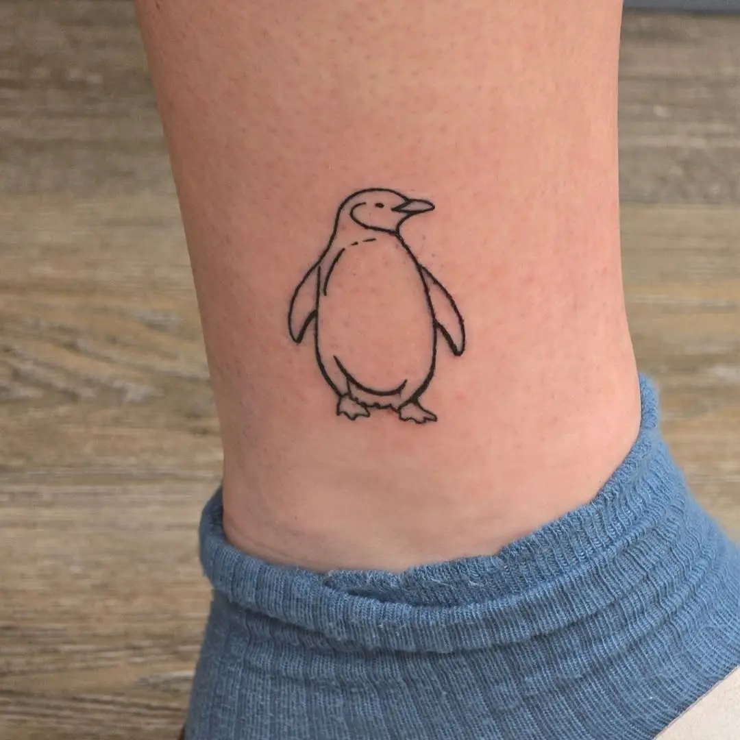 Charming minimalist penguin tattoo on the ankle