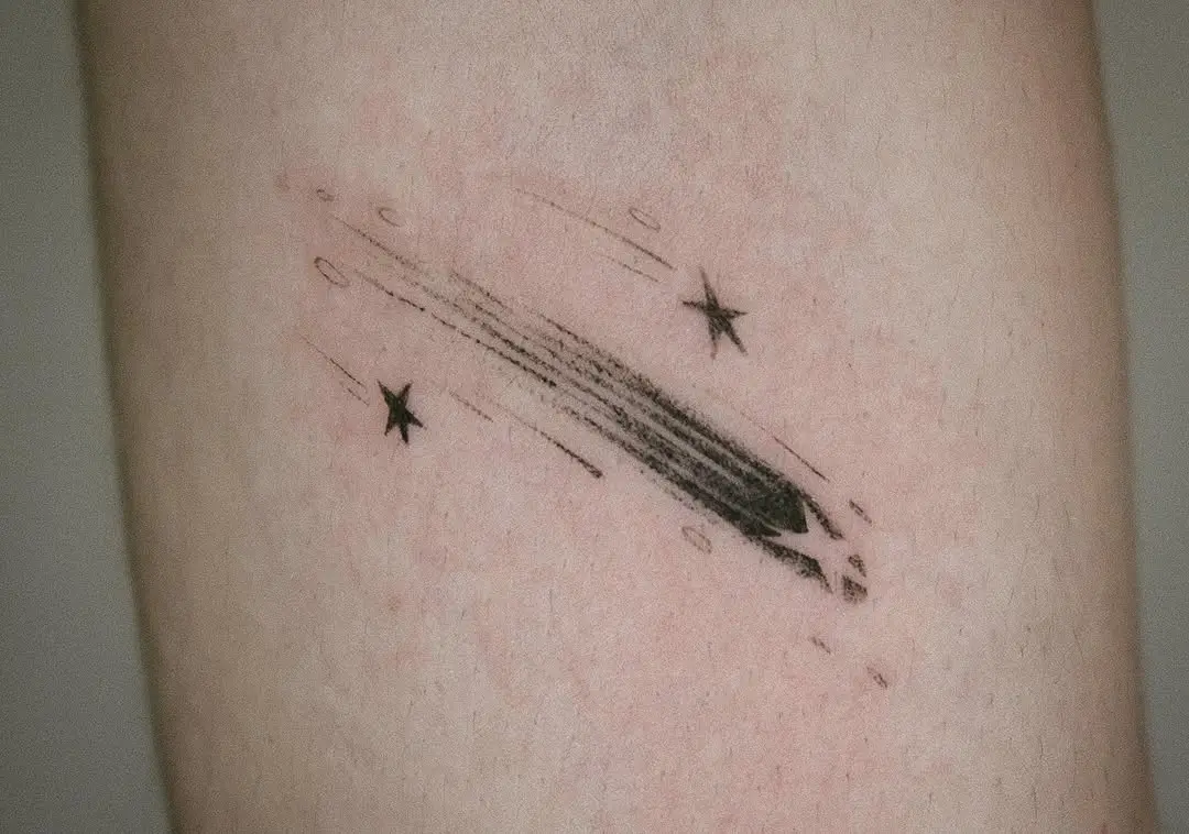 Sleek and minimal shooting star tattoo design