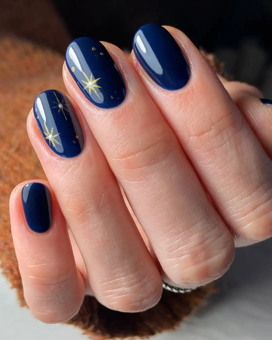 Elegant navy nails with sparkling gold accents