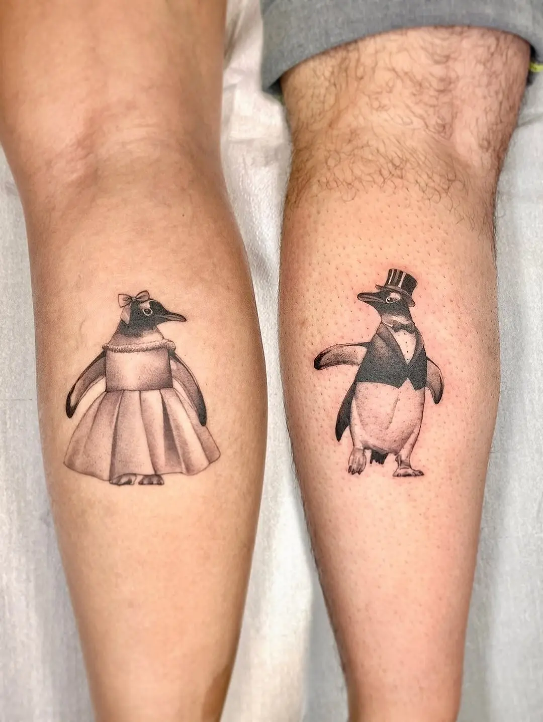 Charming couple tattoos featuring stylish penguins