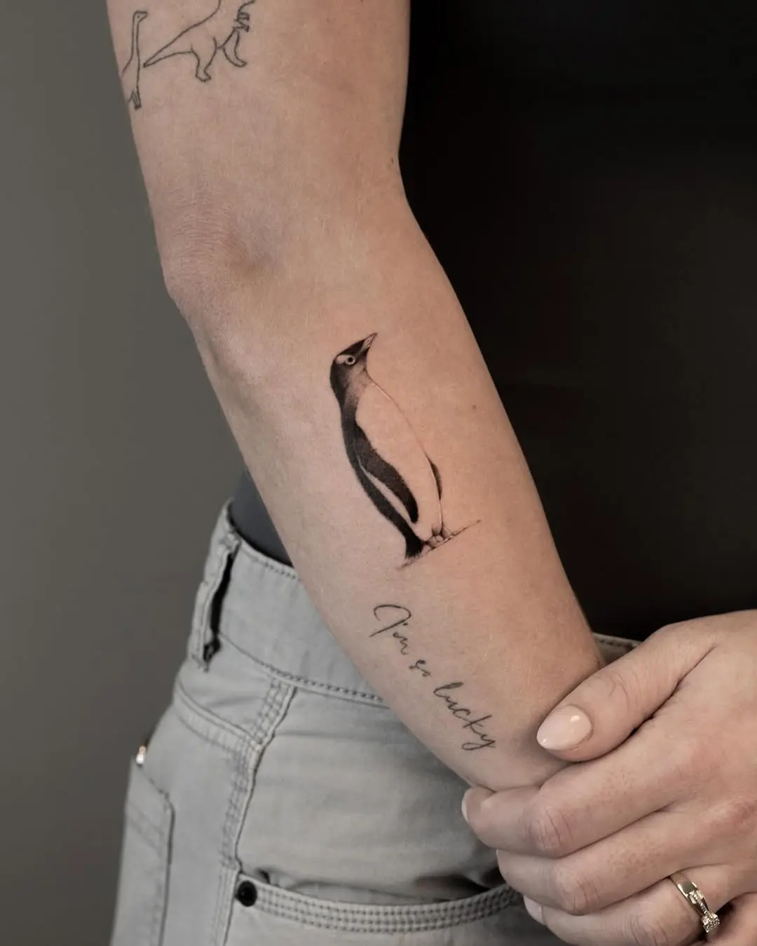 Elegant realism in a penguin tattoo design