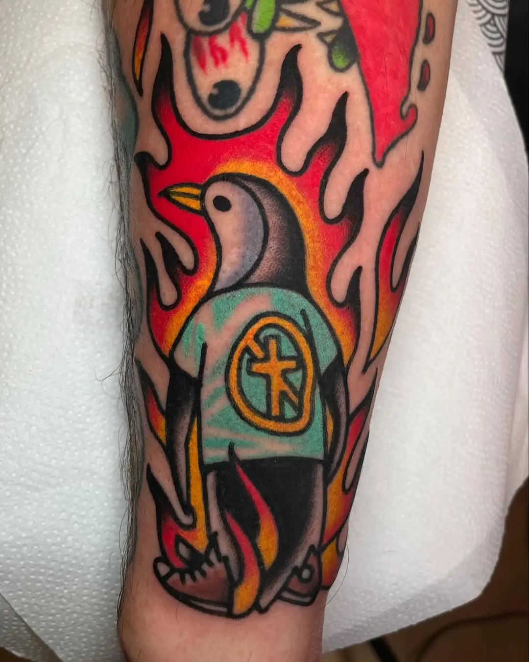 Vibrant Penguin Tattoo with Flames and Style