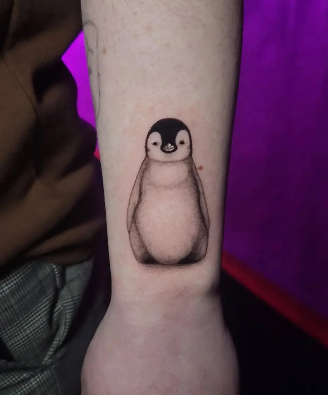 Charming penguin tattoo exuding playful vibes