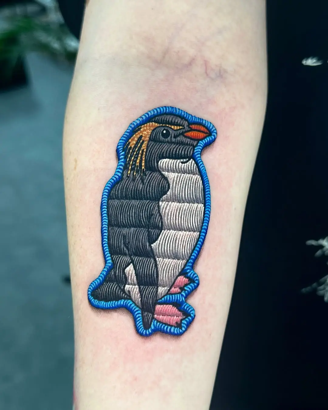 Vibrant embroidered penguin tattoo design idea