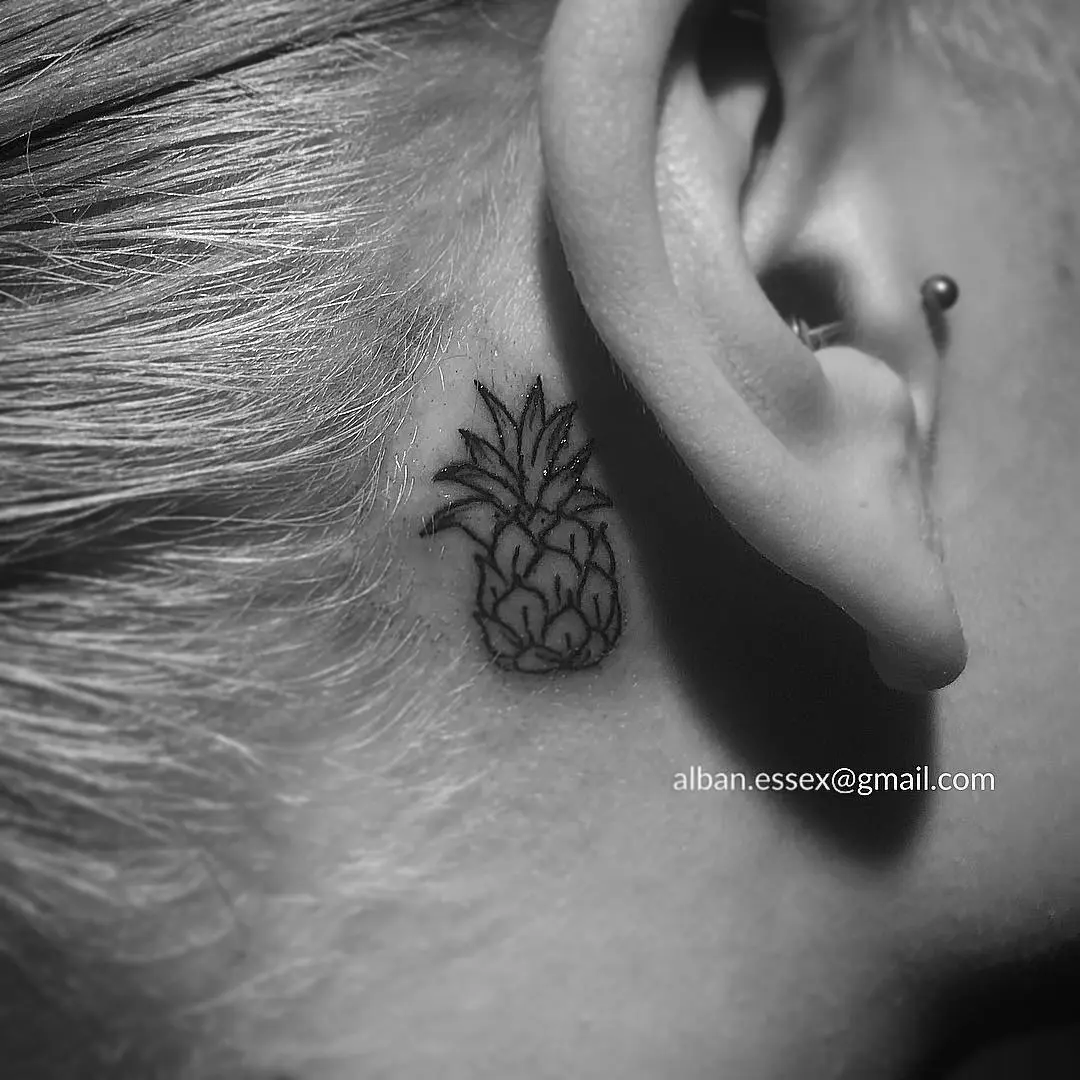 Stylish minimalist pineapple tattoo behind the ear