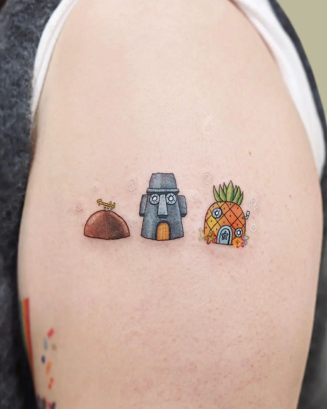 Whimsical pineapple tattoo with ocean elements