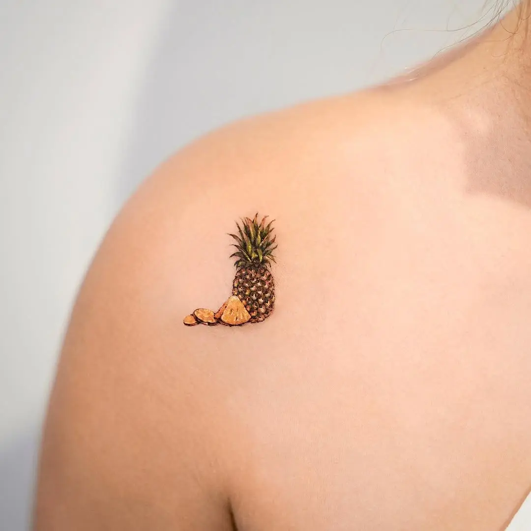 Charming pineapple tattoo adorning the shoulder