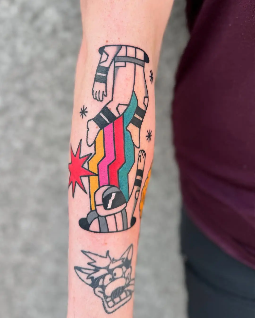 Vibrant pop art astronaut tattoo showcases bold style