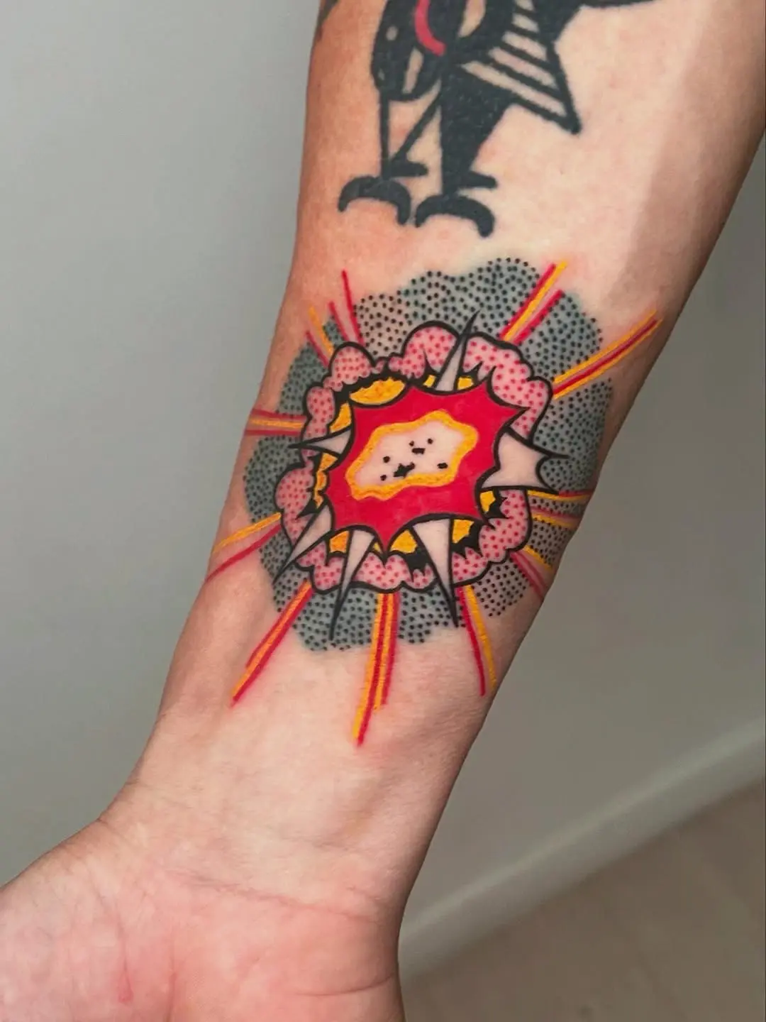 Vibrant explosion tattoo with playful design