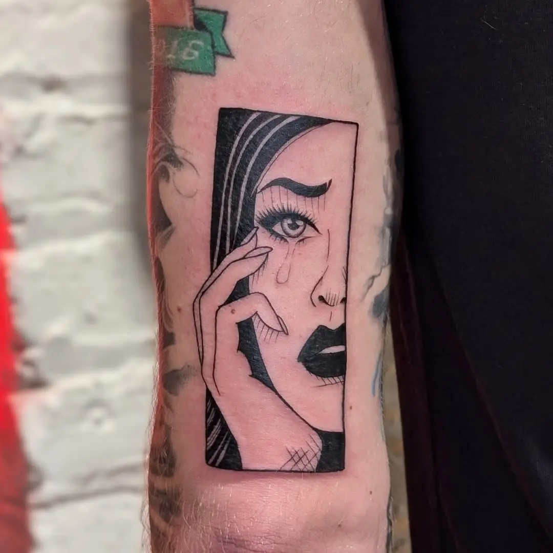 Emotional pop art tattoo of a teary woman