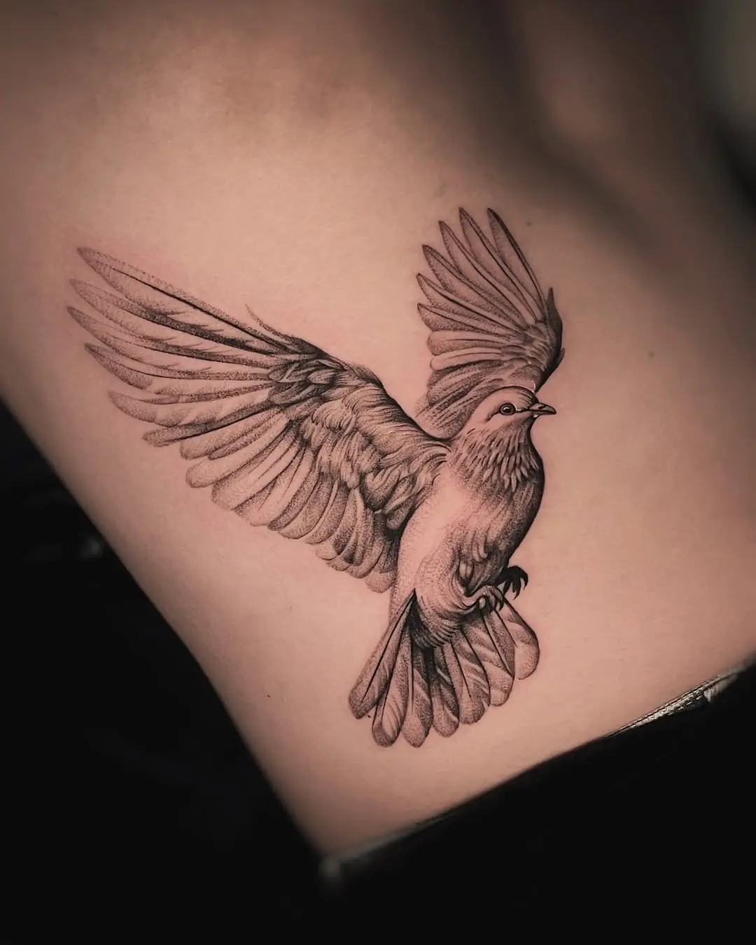 Elegant dove tattoo capturing freedom in flight
