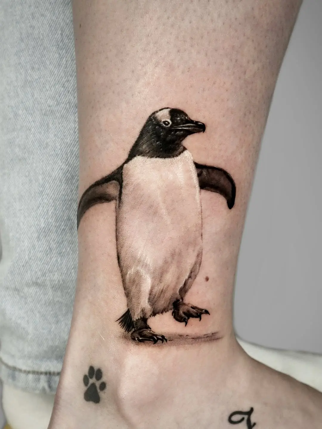 Stylish penguin tattoo with realistic details
