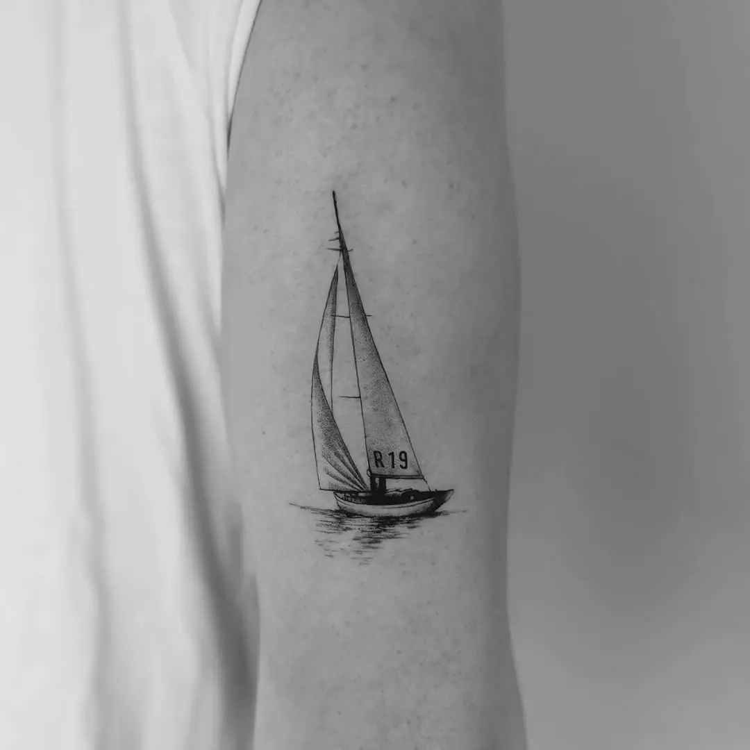 Elegant sailboat tattoo on the forearm