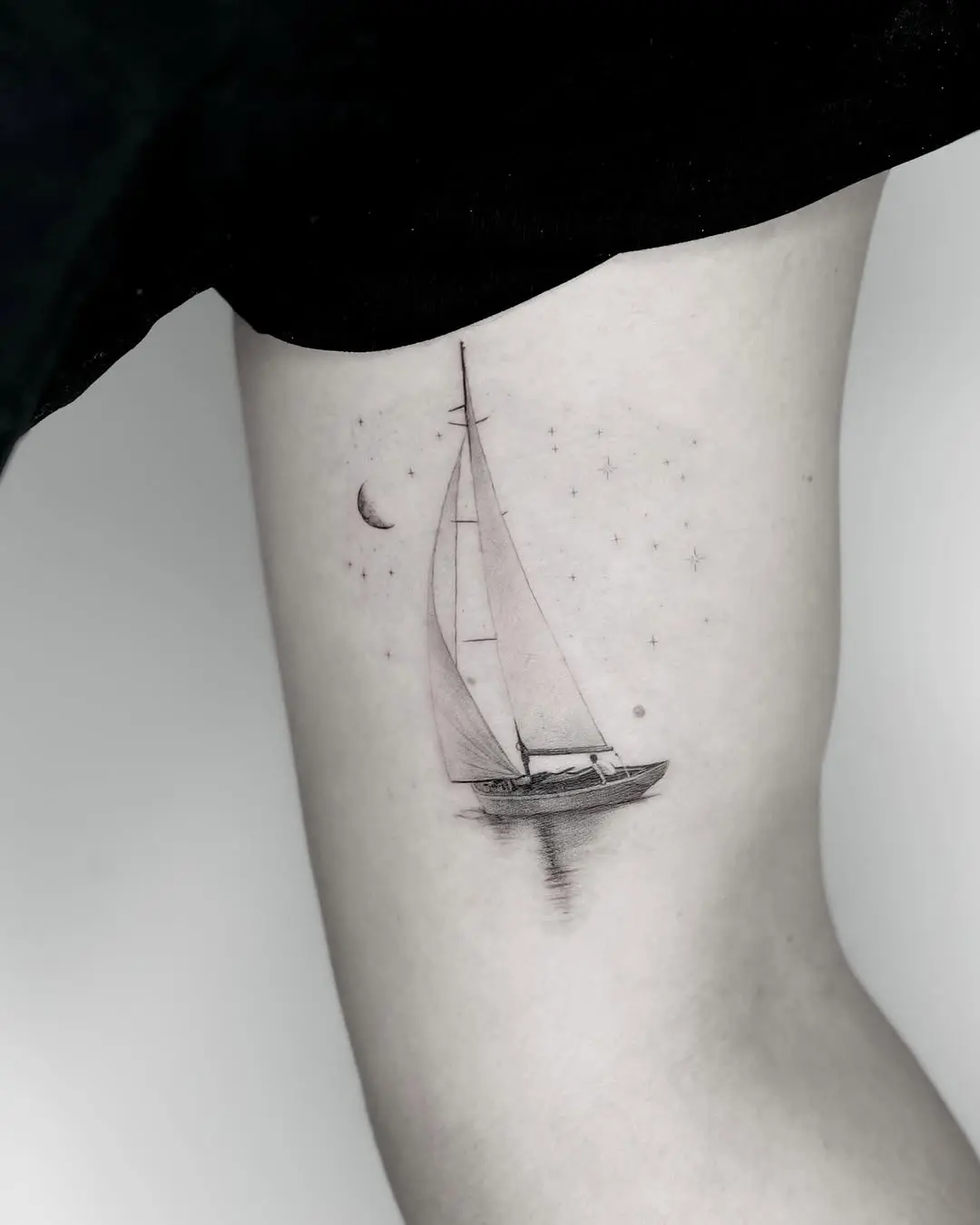 Elegant sailing tattoo with celestial elements