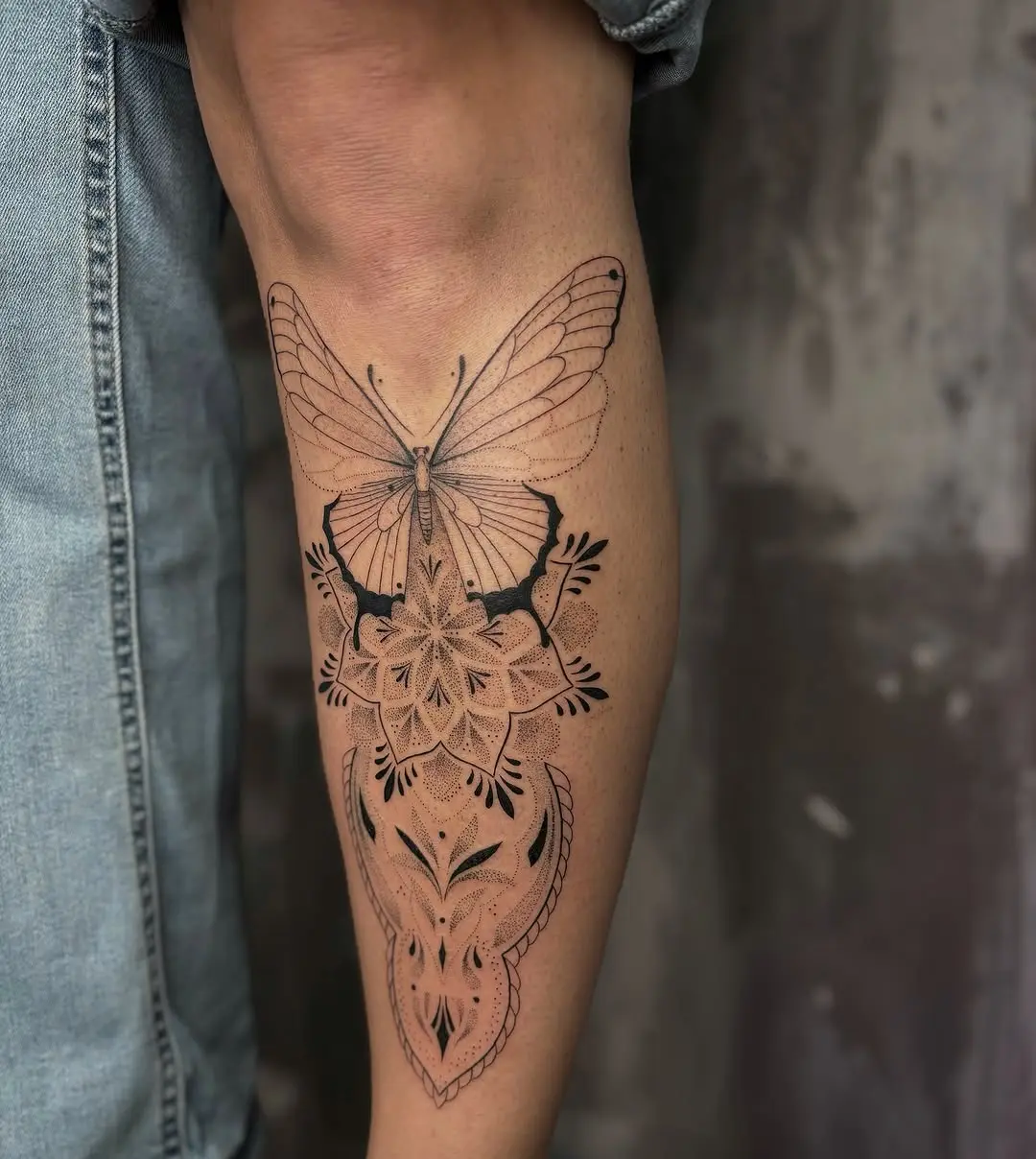 Elegant butterfly tattoo on the shin area
