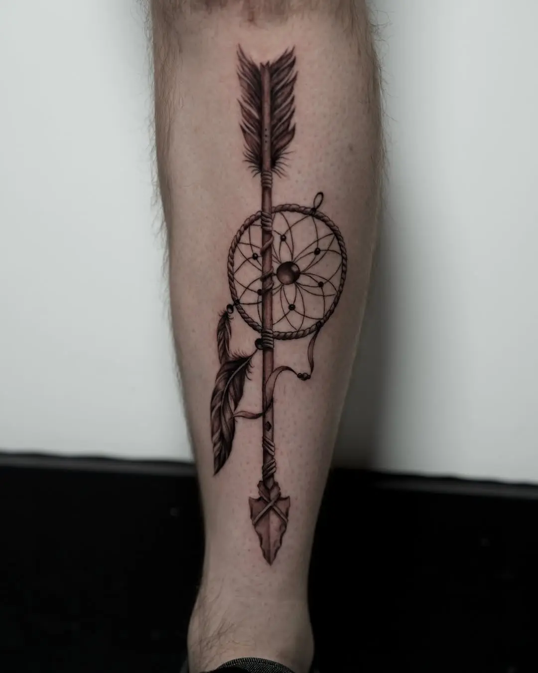 Dynamic dreamcatcher arrow tattoo for shin