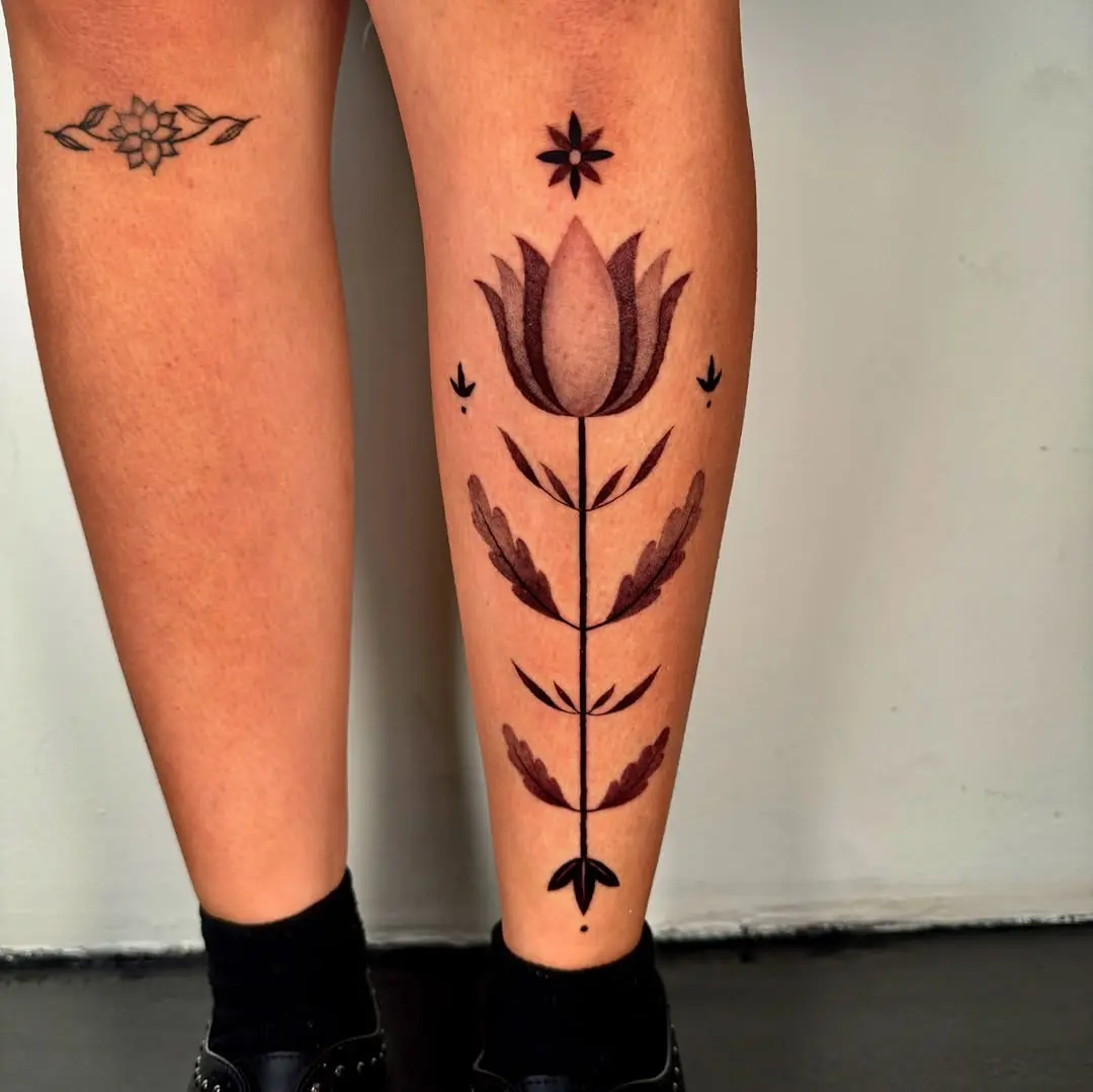Stunning floral shin tattoo with bold lines