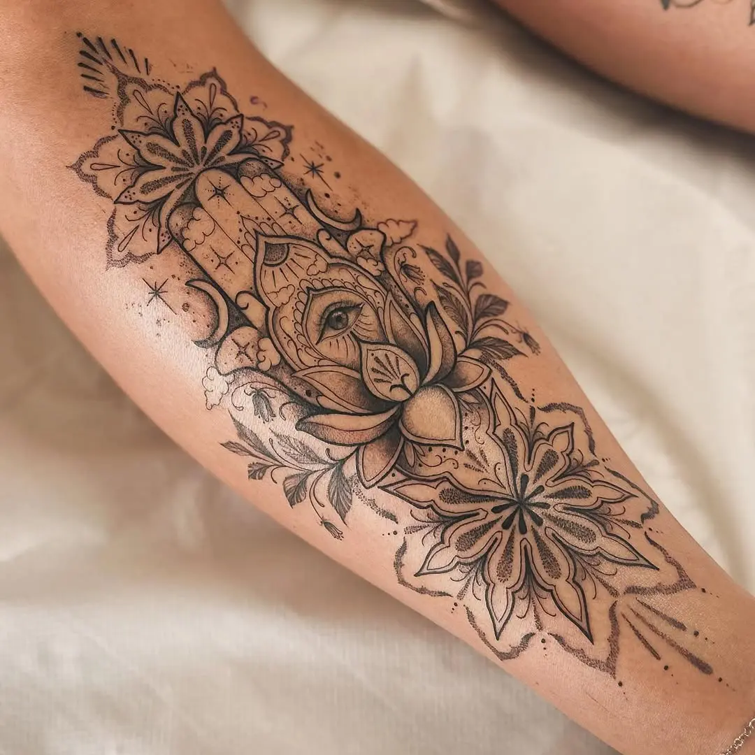 Mystical hand and floral shin tattoo design