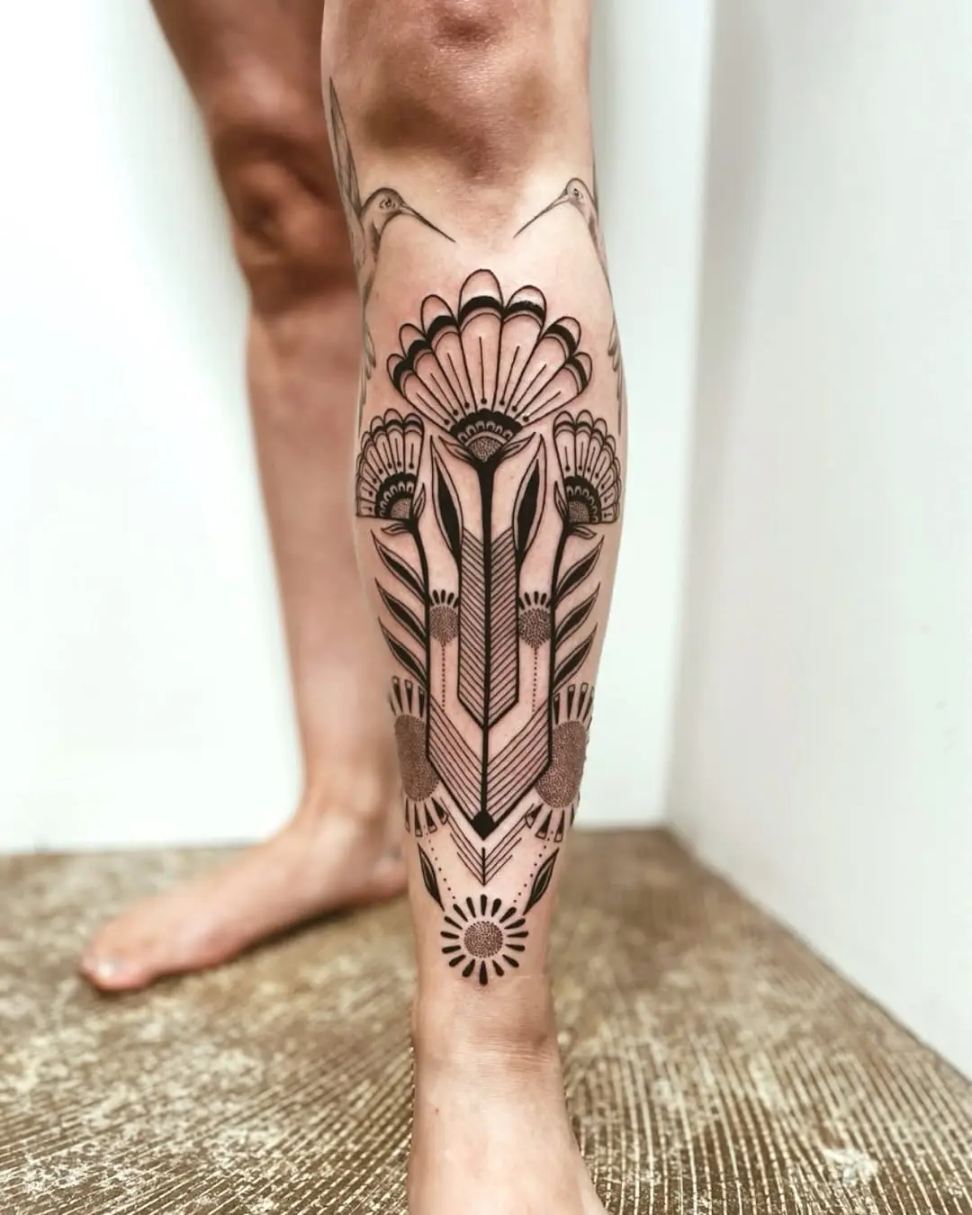 Elegant floral and geometric shin tattoo design