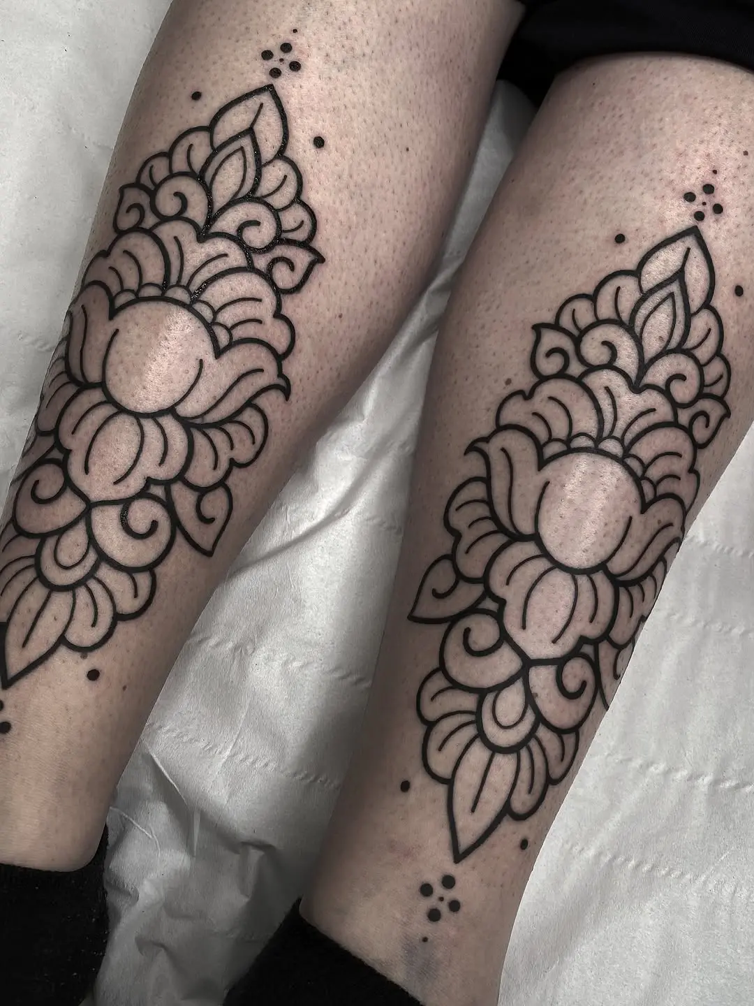Elegant floral pattern tattoos on shins