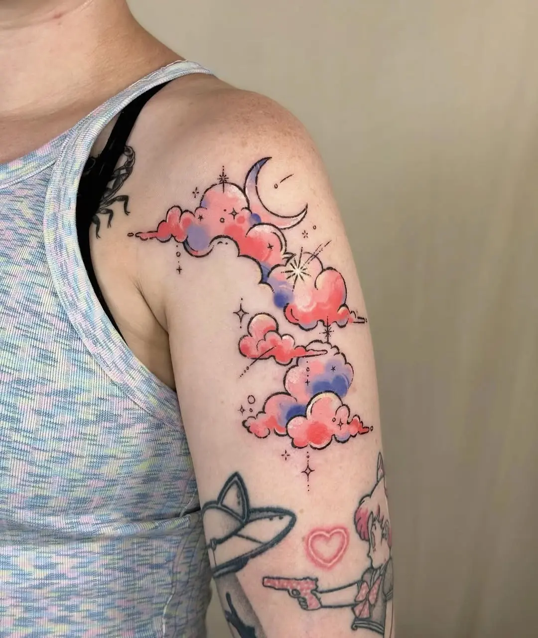 Whimsical clouds and stars shooting tattoo art