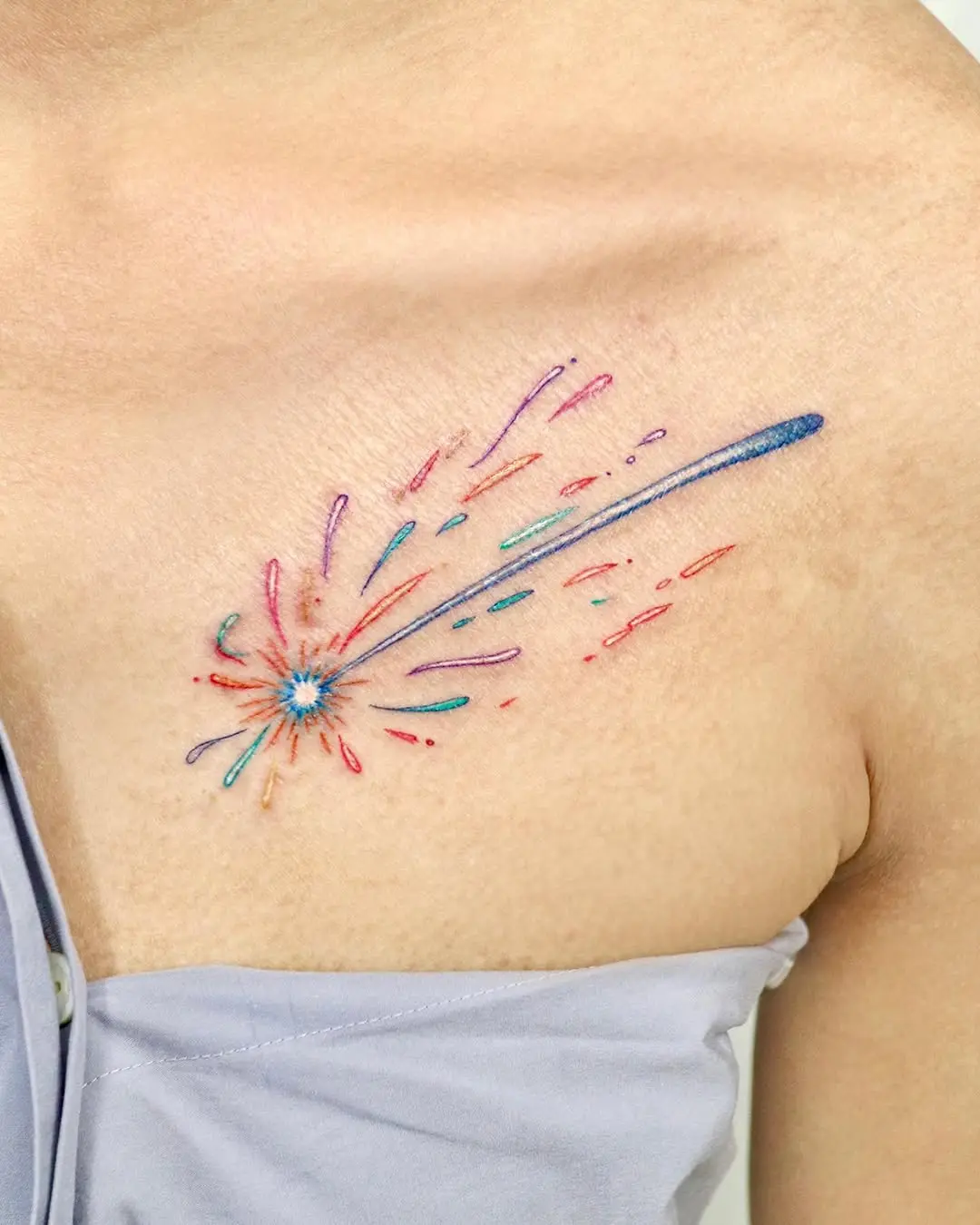 Vibrant shooting star tattoo with colorful trails