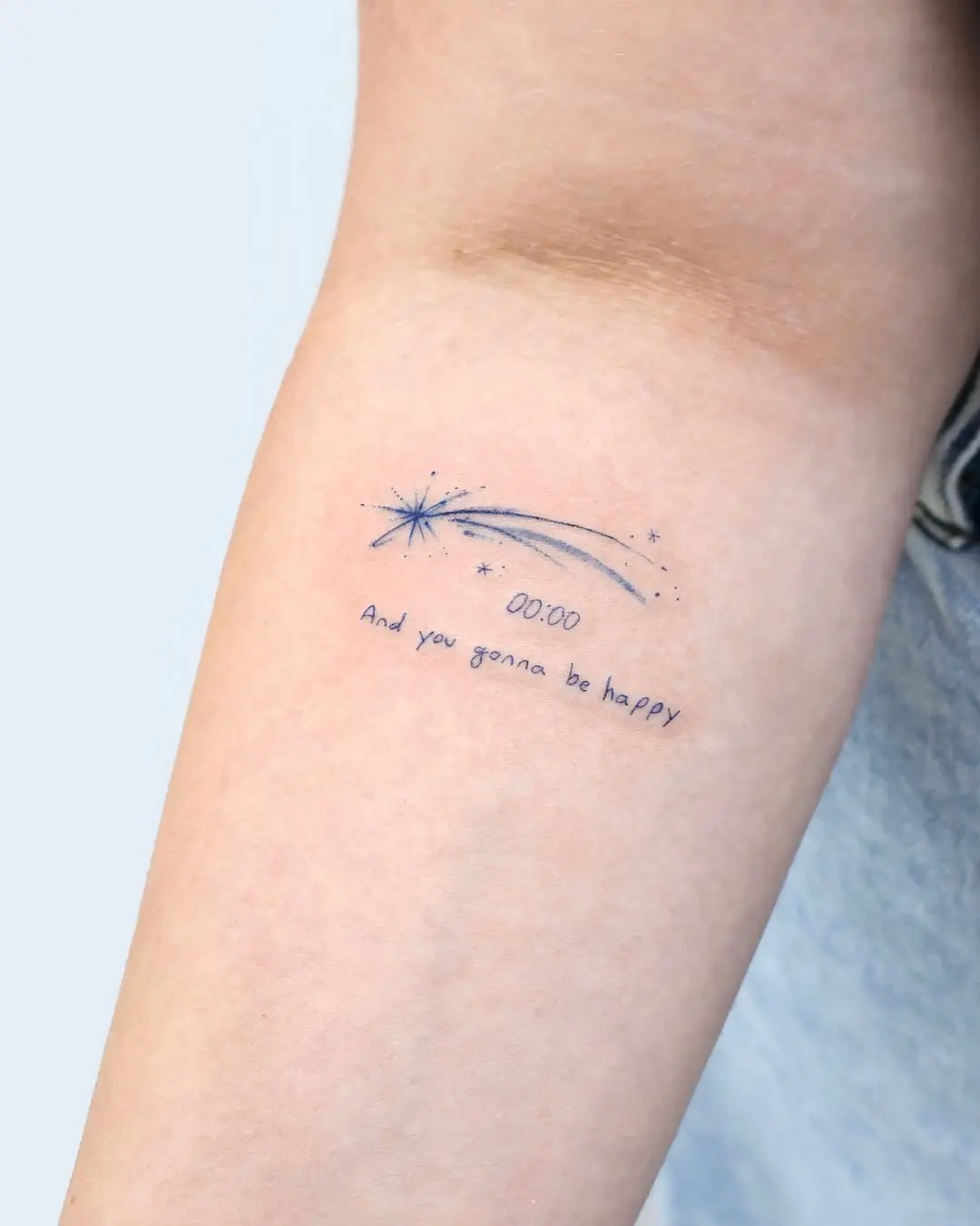 Minimalist shooting star tattoo with a quote