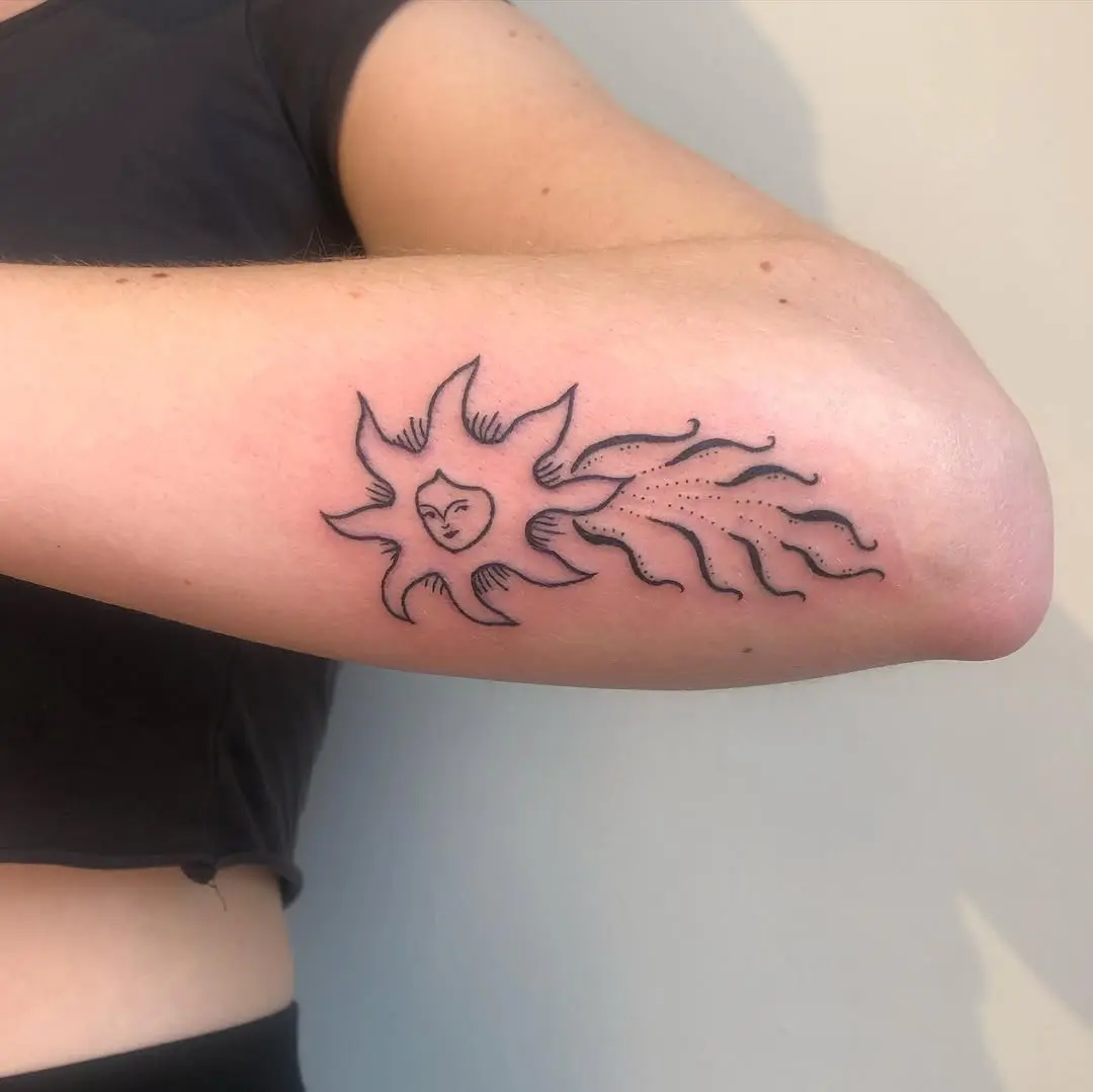 Charming shooting star tattoo with a sun design