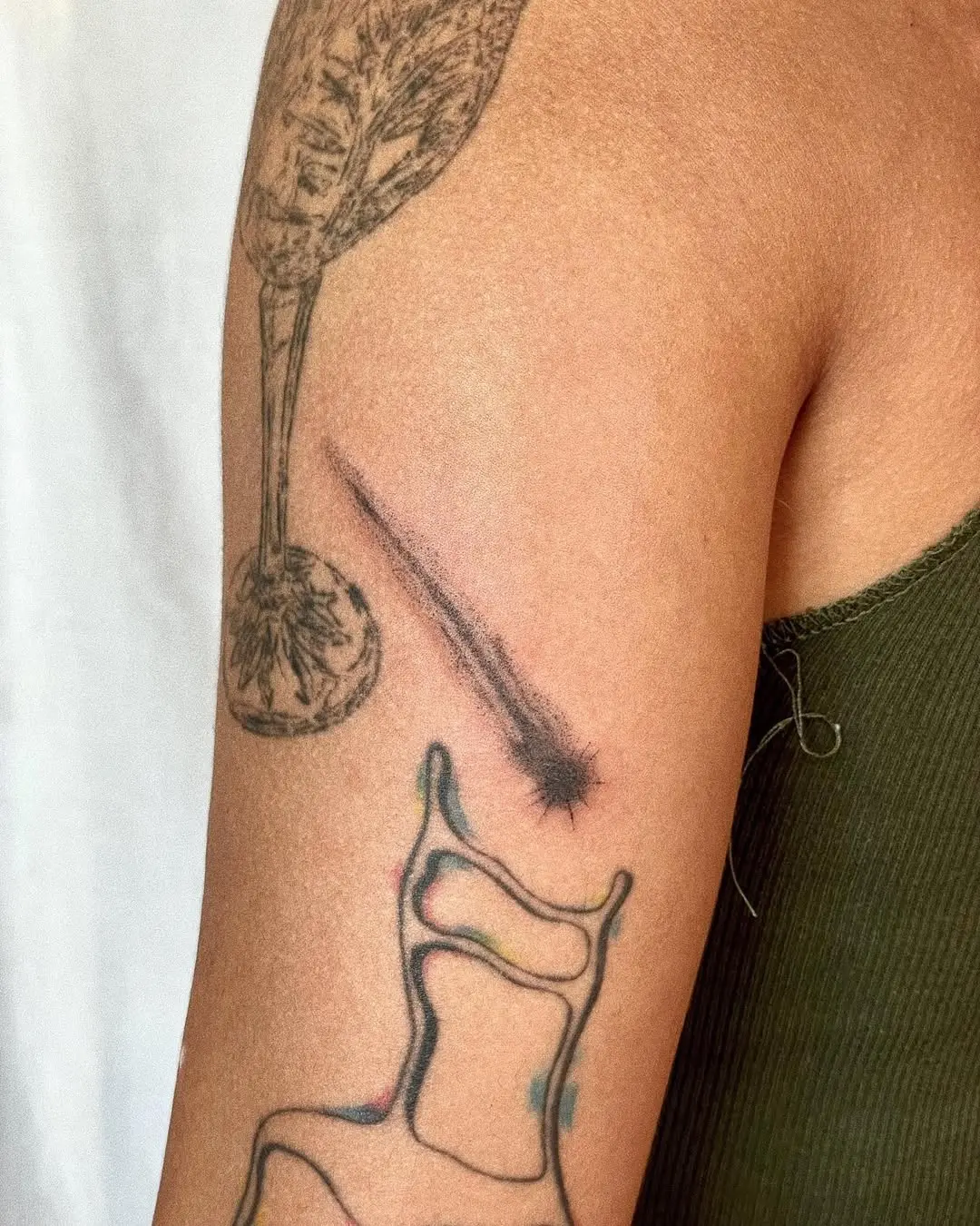 Elegant shooting star tattoo on the arm