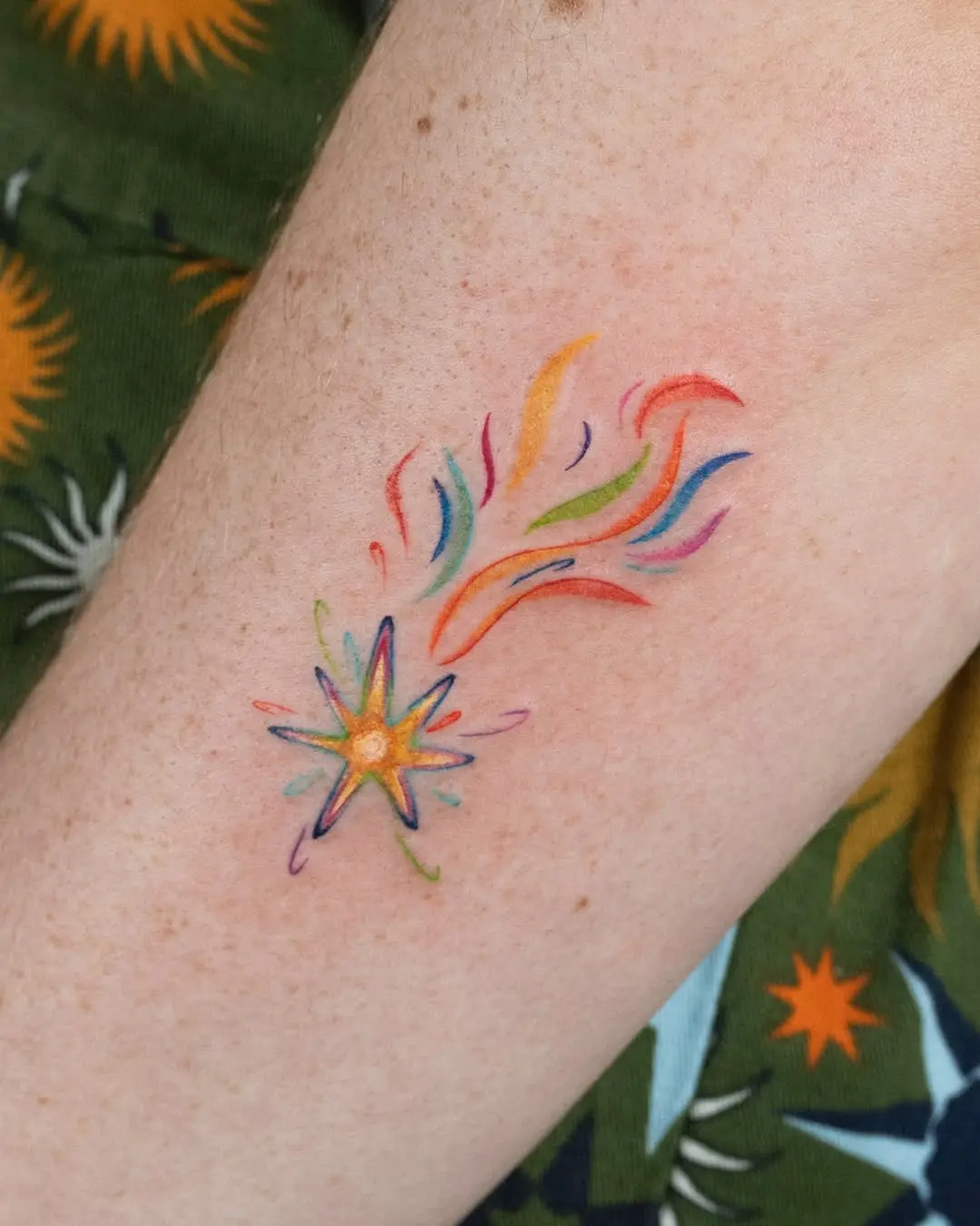 Colorful shooting star tattoo with vibrant trails