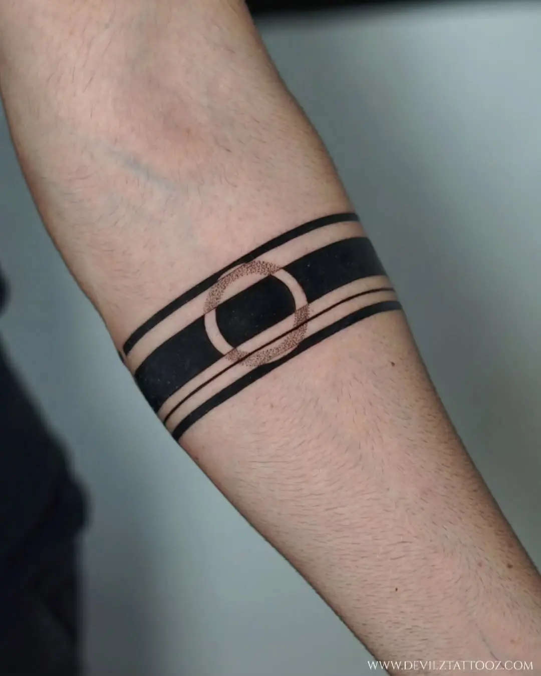 Bold armband tattoo featuring sleek design elements.